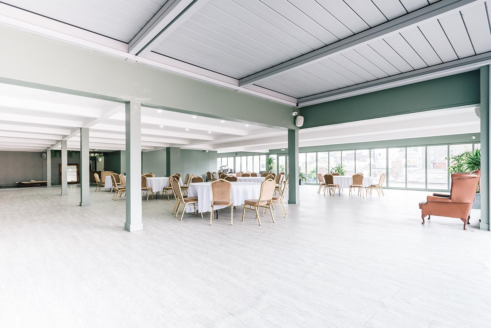 John Rylands Rooftop in Manchester Hall, spacious event venue with large windows for gatherings.