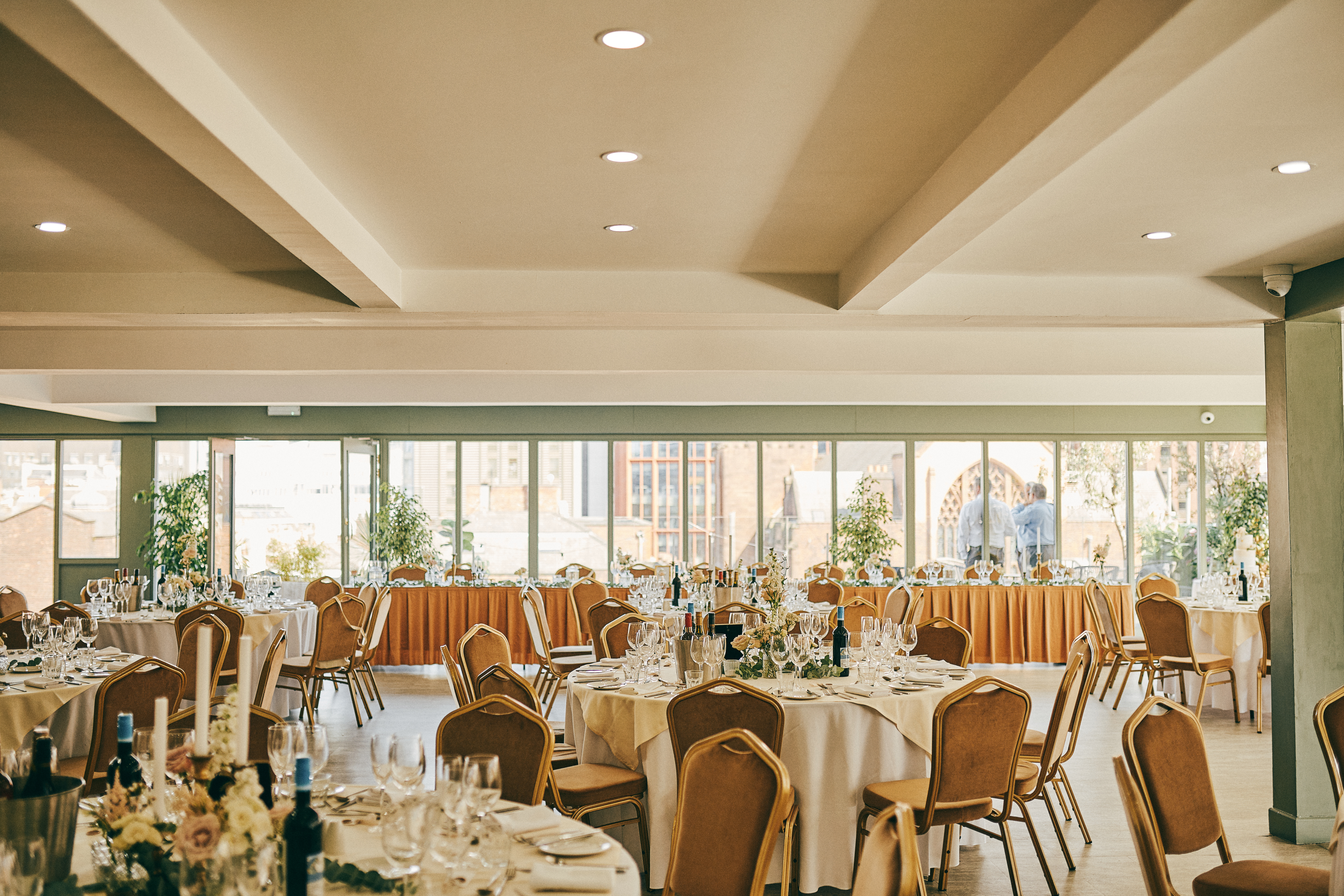John Rylands Rooftop event space with elegant tables, ideal for gatherings and networking.
