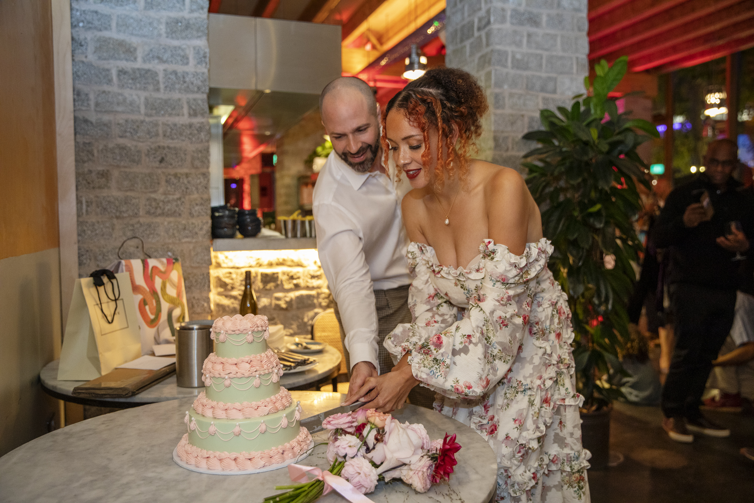 Celebratory cake in The Greenroom, showcasing joyful couple at a stylish event.