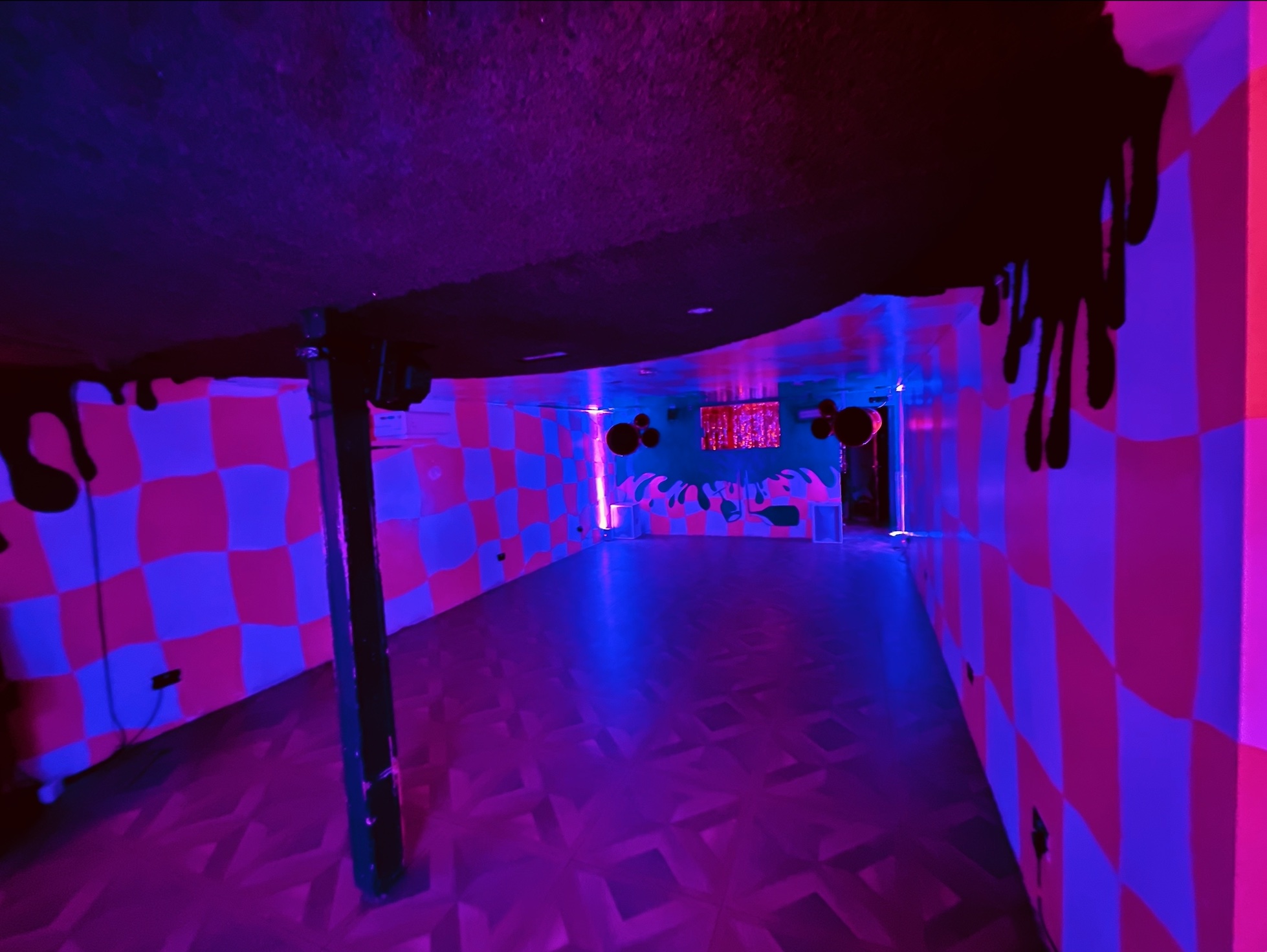 Vibrant Bonkers Bar event space with checkerboard patterns, perfect for parties and gatherings.