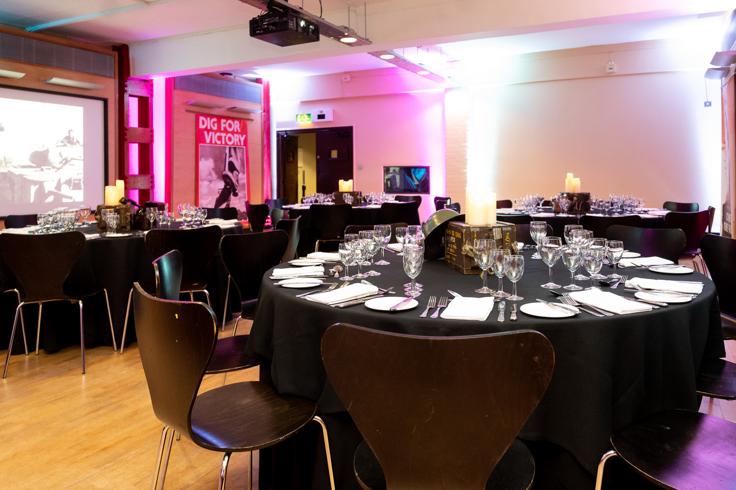 HCA Auditorium with elegant round tables, ideal for corporate events and presentations.