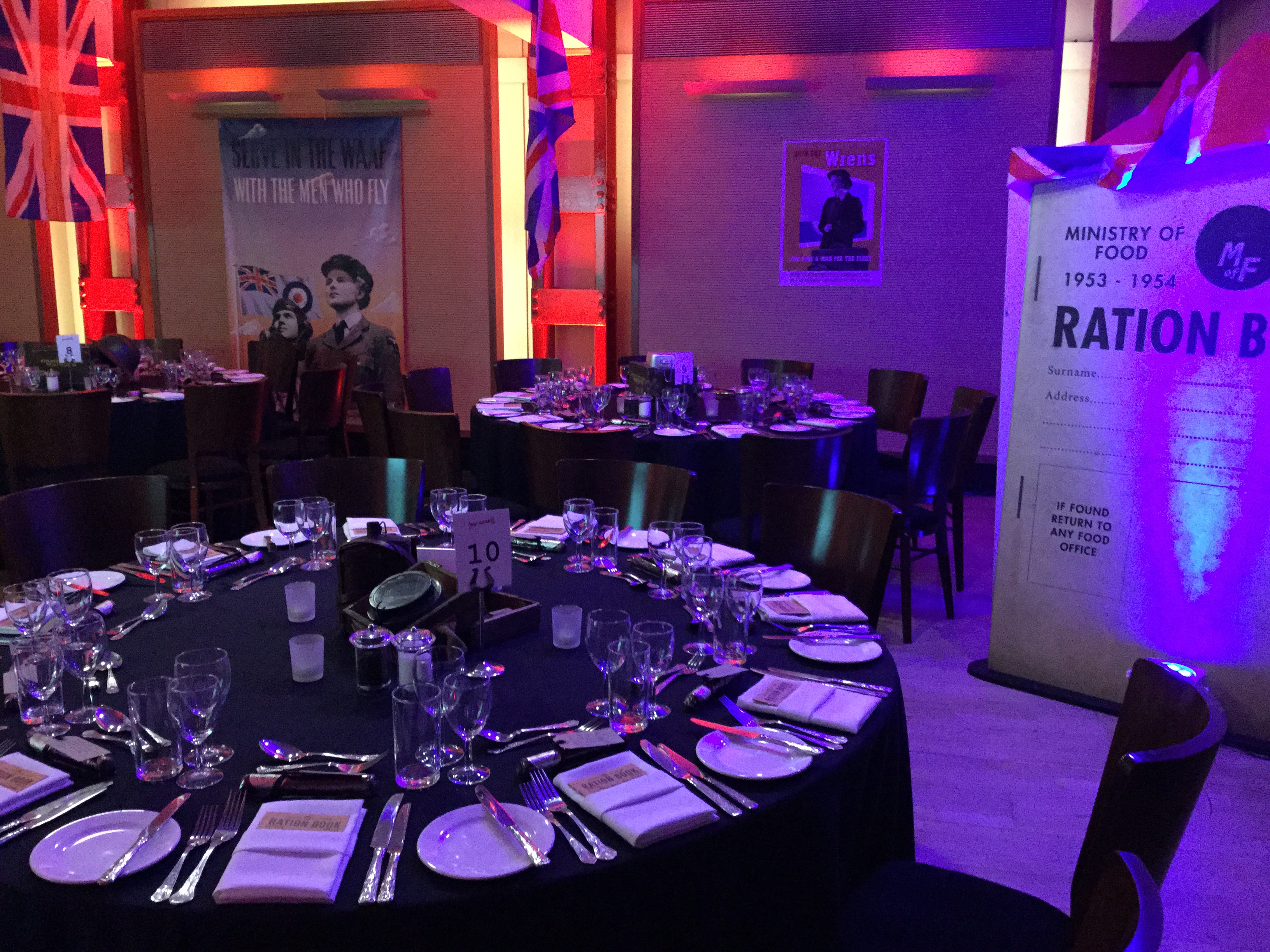 HCA Auditorium set for a formal dinner with elegant tables and vibrant decor.