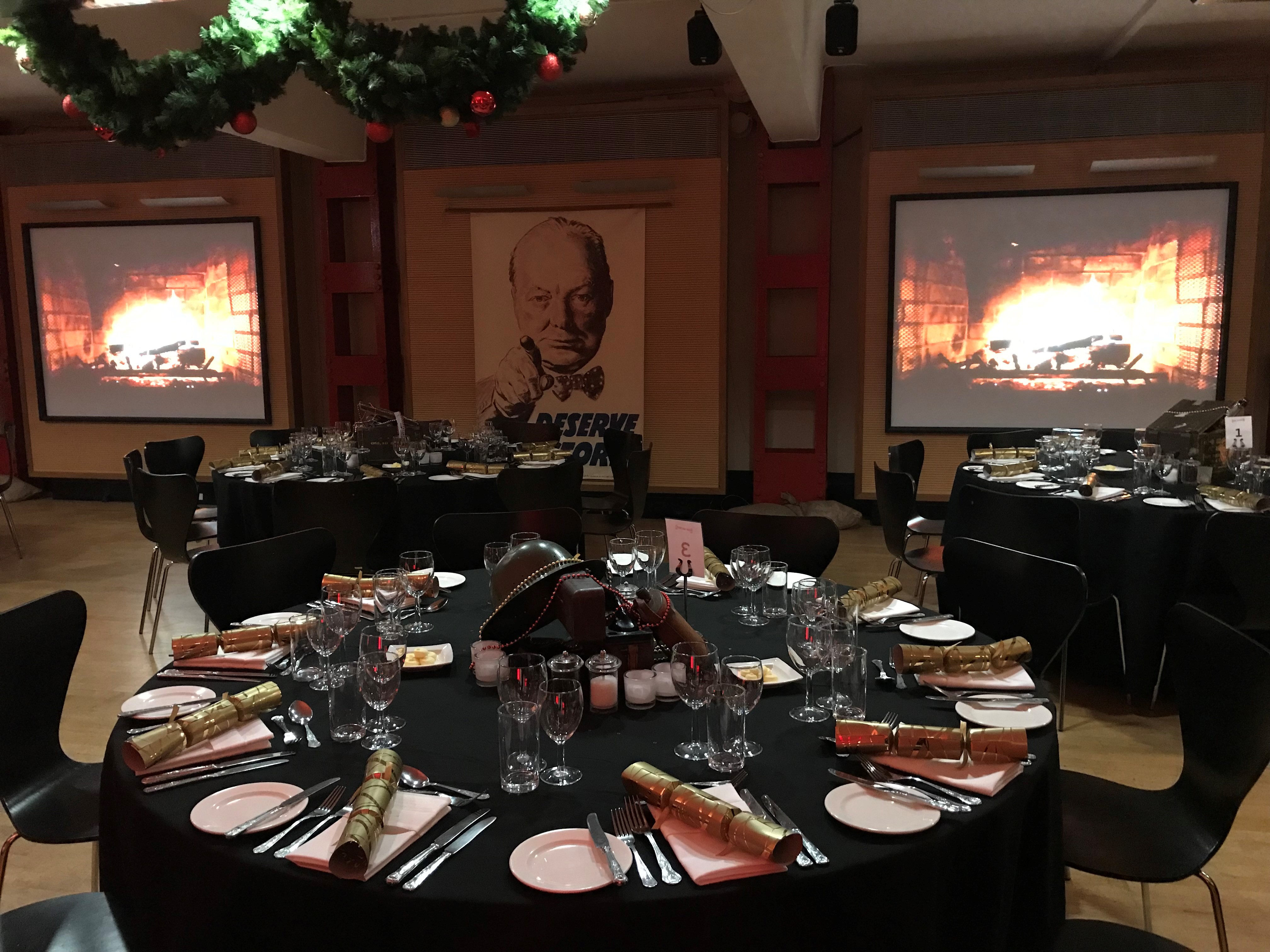 HCA Auditorium dining setup with elegant tables for holiday celebrations or corporate events.