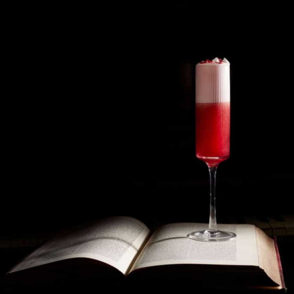 Elegant cocktail in tall glass, vibrant red and white layers for upscale events.