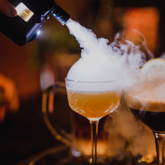 Creative cocktail with smoke effects at The Cocktail Club Exeter event venue.