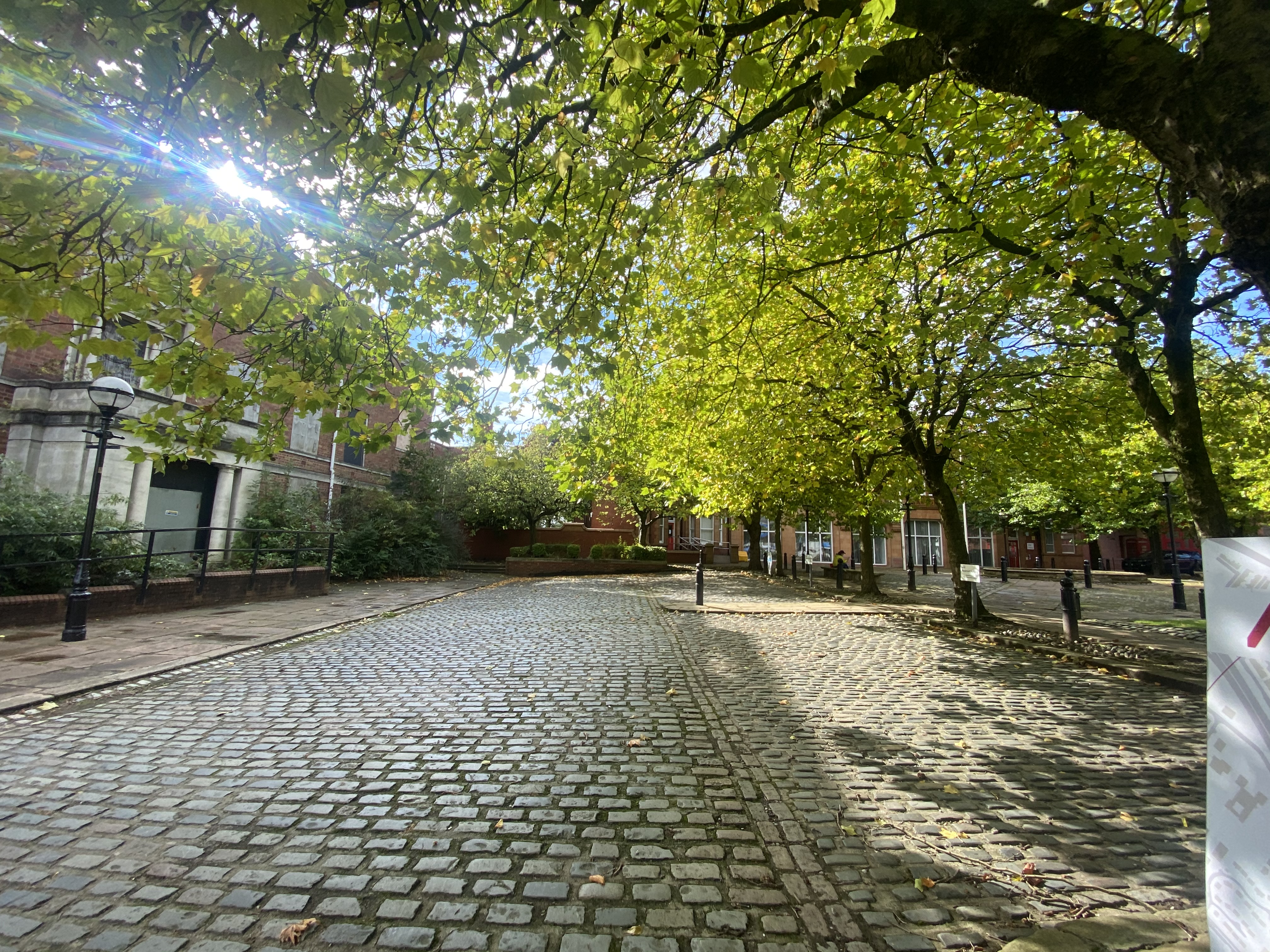 "Elegant outdoor venue with cobblestone pathway for networking events and workshops."