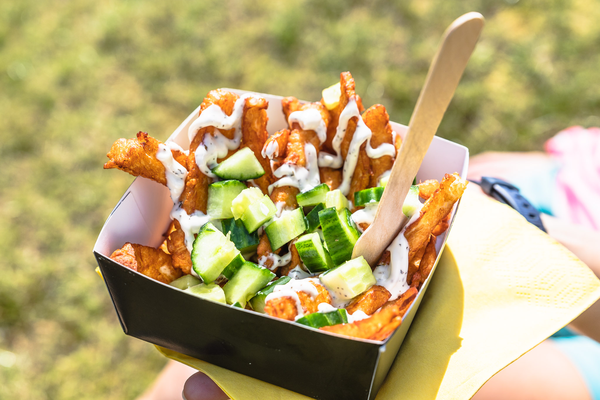 Loaded fries with cucumbers, perfect for outdoor events and casual catering.