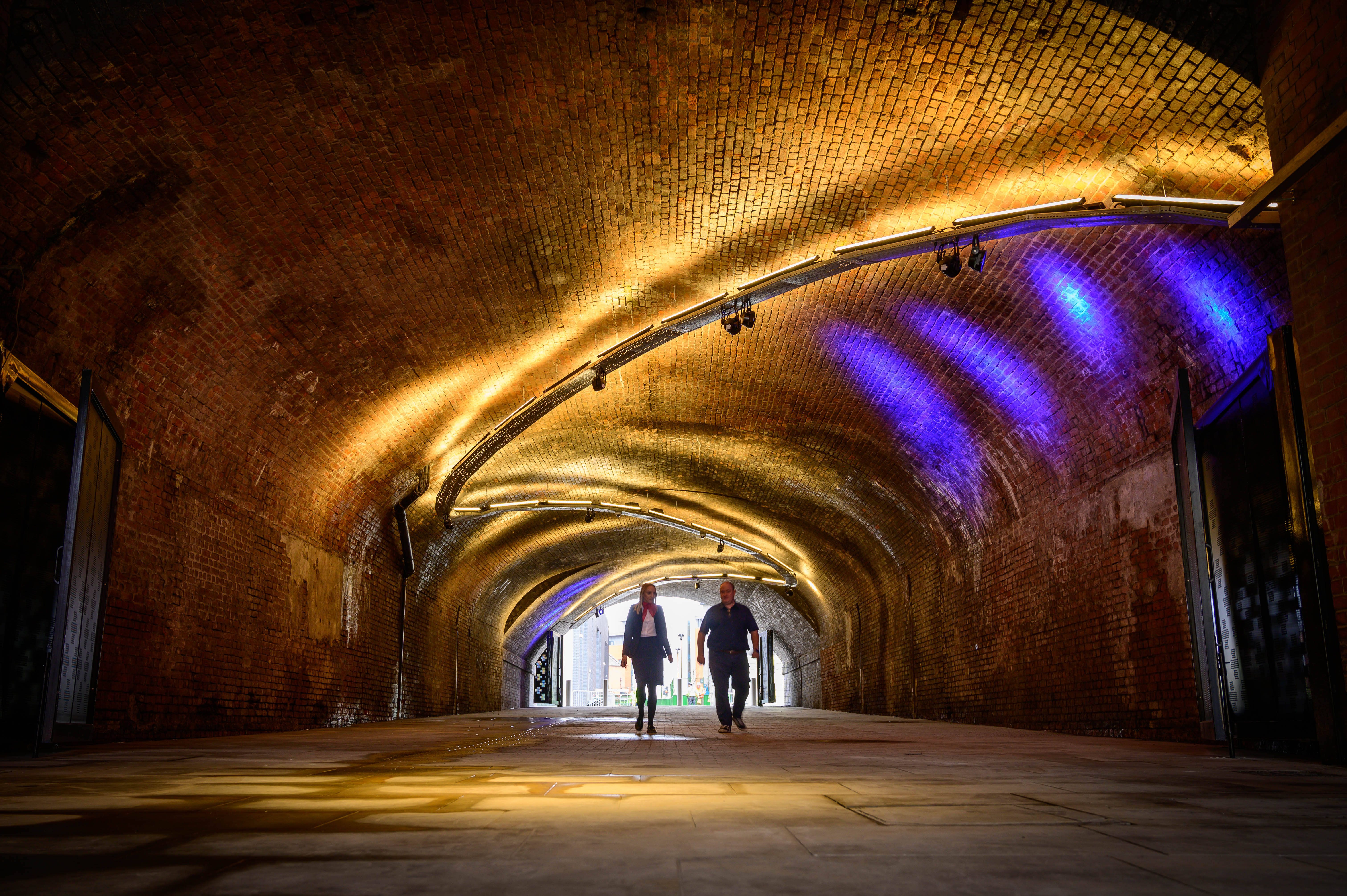 Spacious venue with arched brick ceiling, perfect for events and exhibitions.