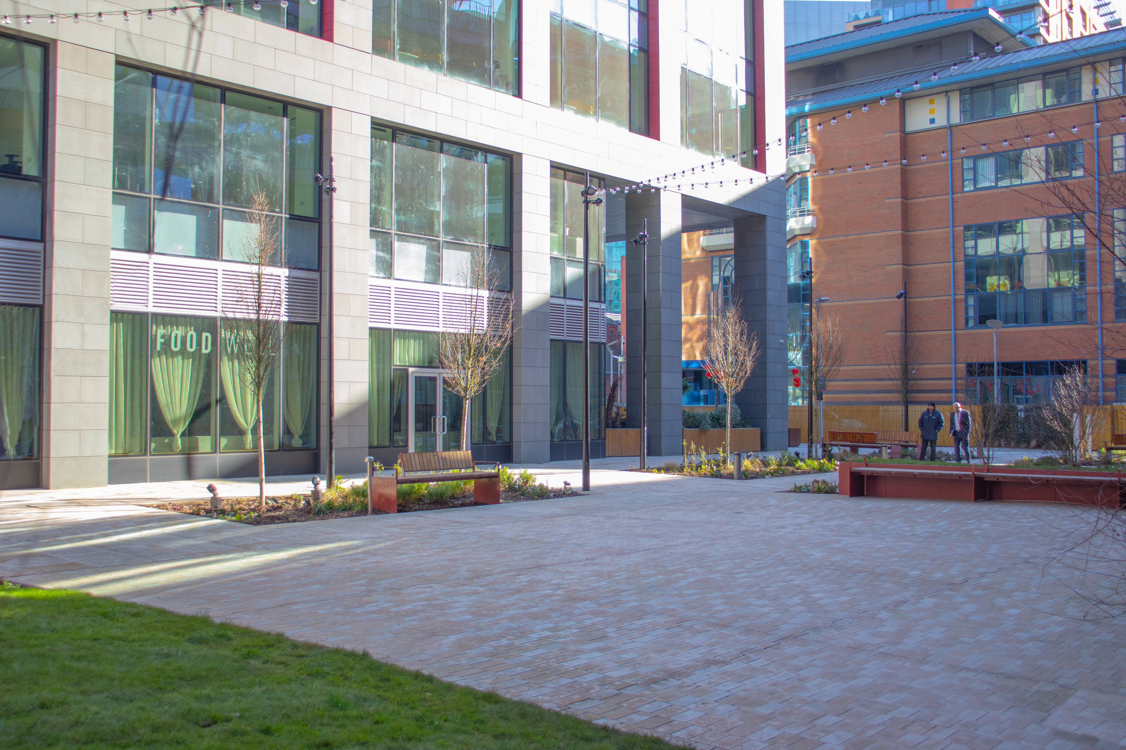 Versatile outdoor event space in New Bailey Square with modern architecture and natural light.