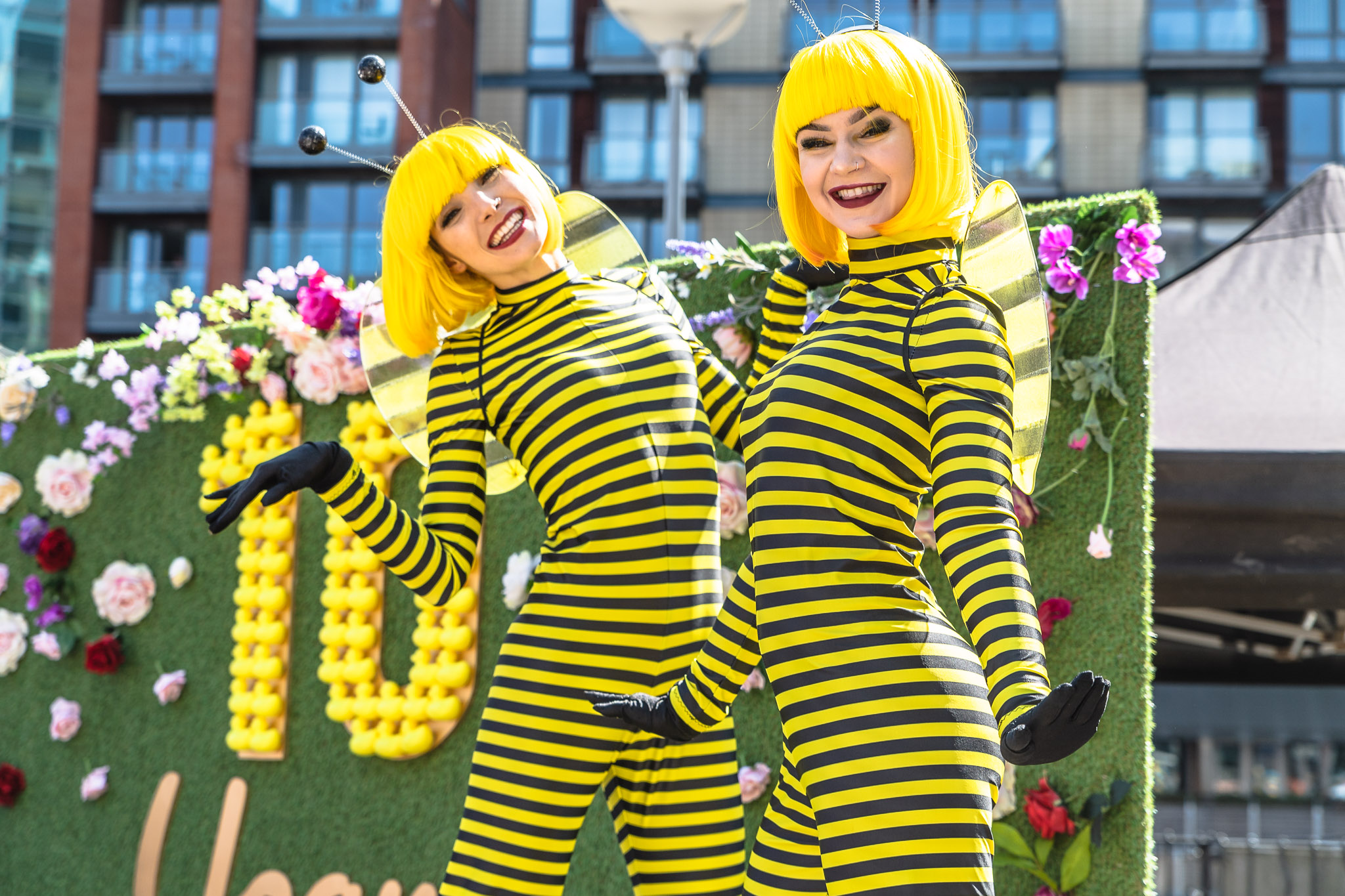 Vibrant bee performers at Stanley Square for family-friendly outdoor events.