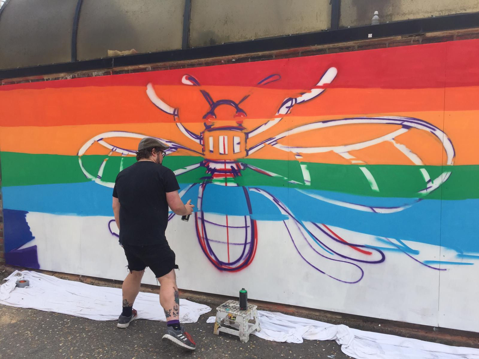 Vibrant bee mural in Stanley Square, perfect for outdoor events and community gatherings.
