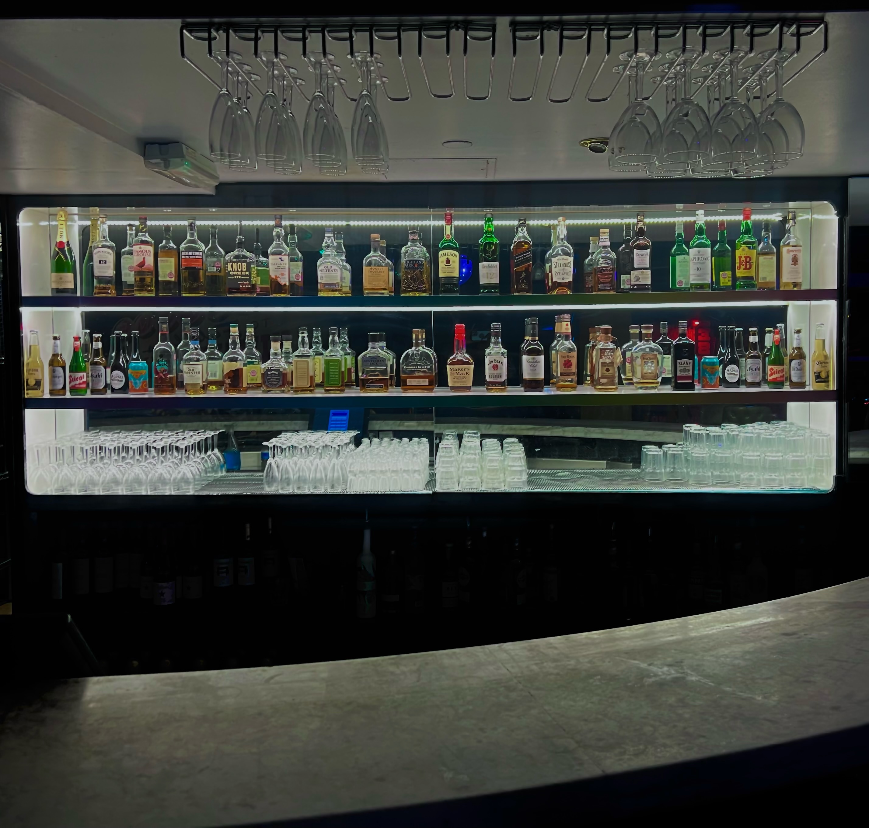 The KingPin Suite bar with premium spirits, perfect for cocktail receptions and networking events.