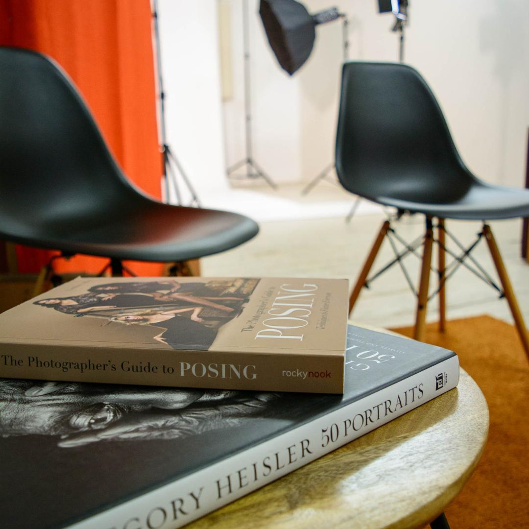 Photography workshop setup in Studio 5 Manchester with stylish chairs and books.