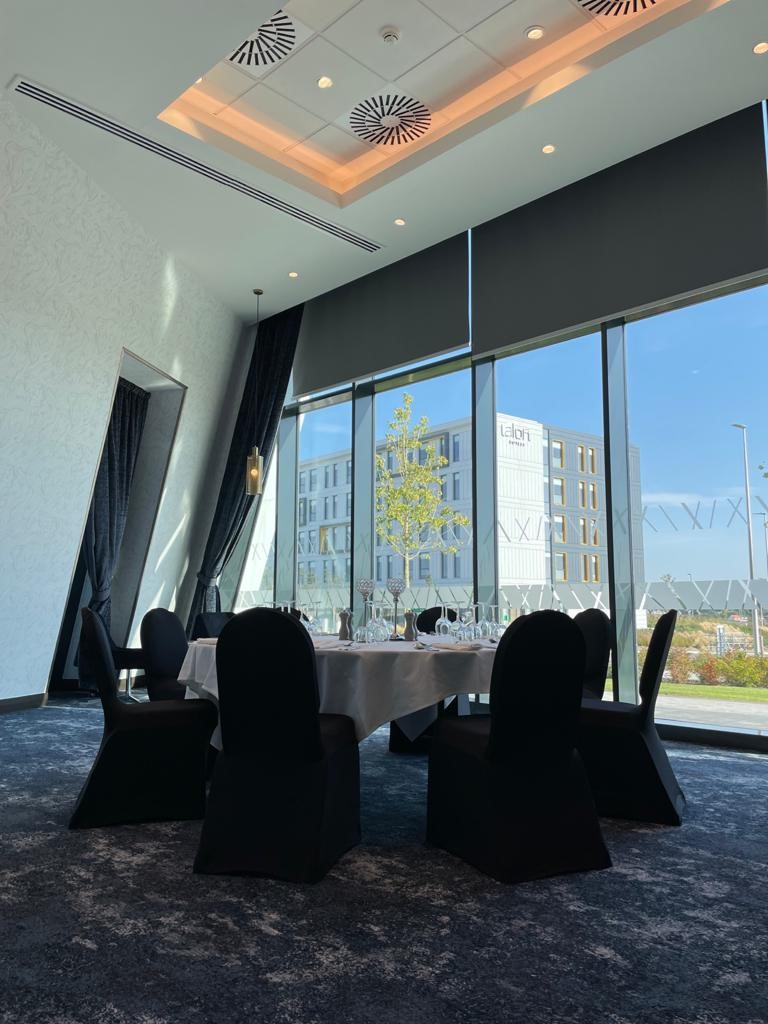 Kirkhill Suite at Hilton Aberdeen TECA: elegant meeting space with round table and natural light.