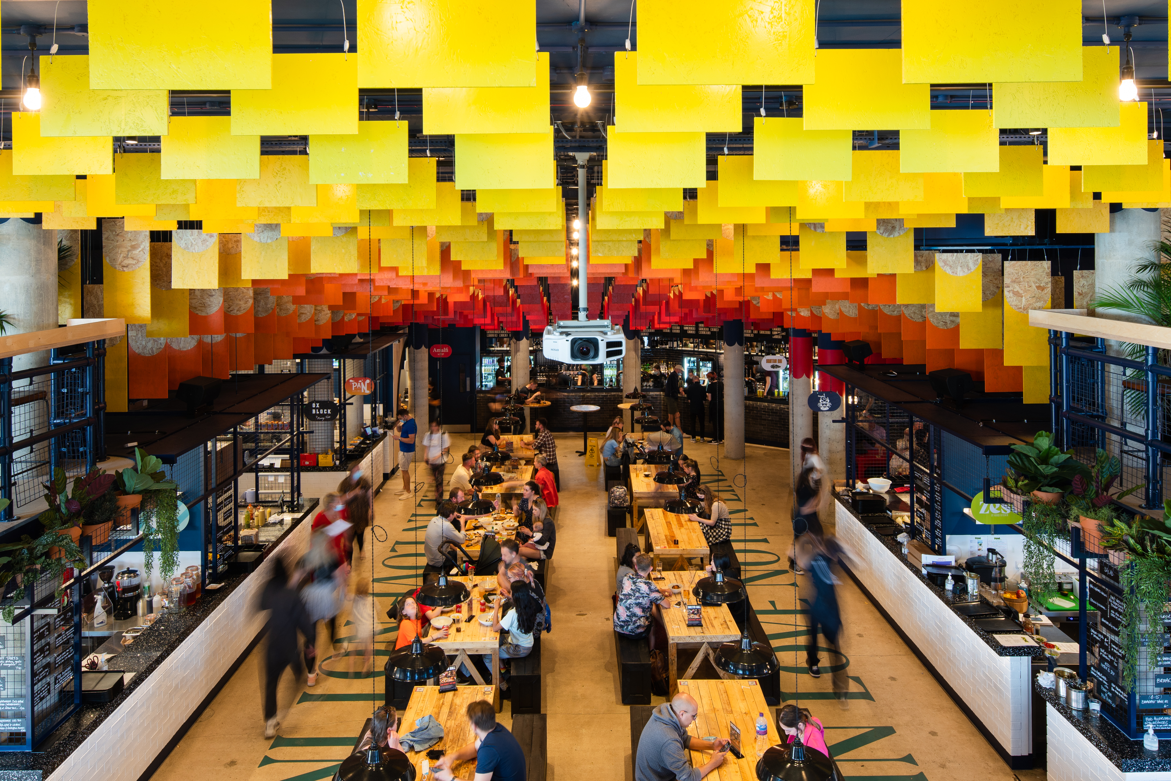 Vibrant Shelter Hall venue with communal tables for networking events and gatherings.