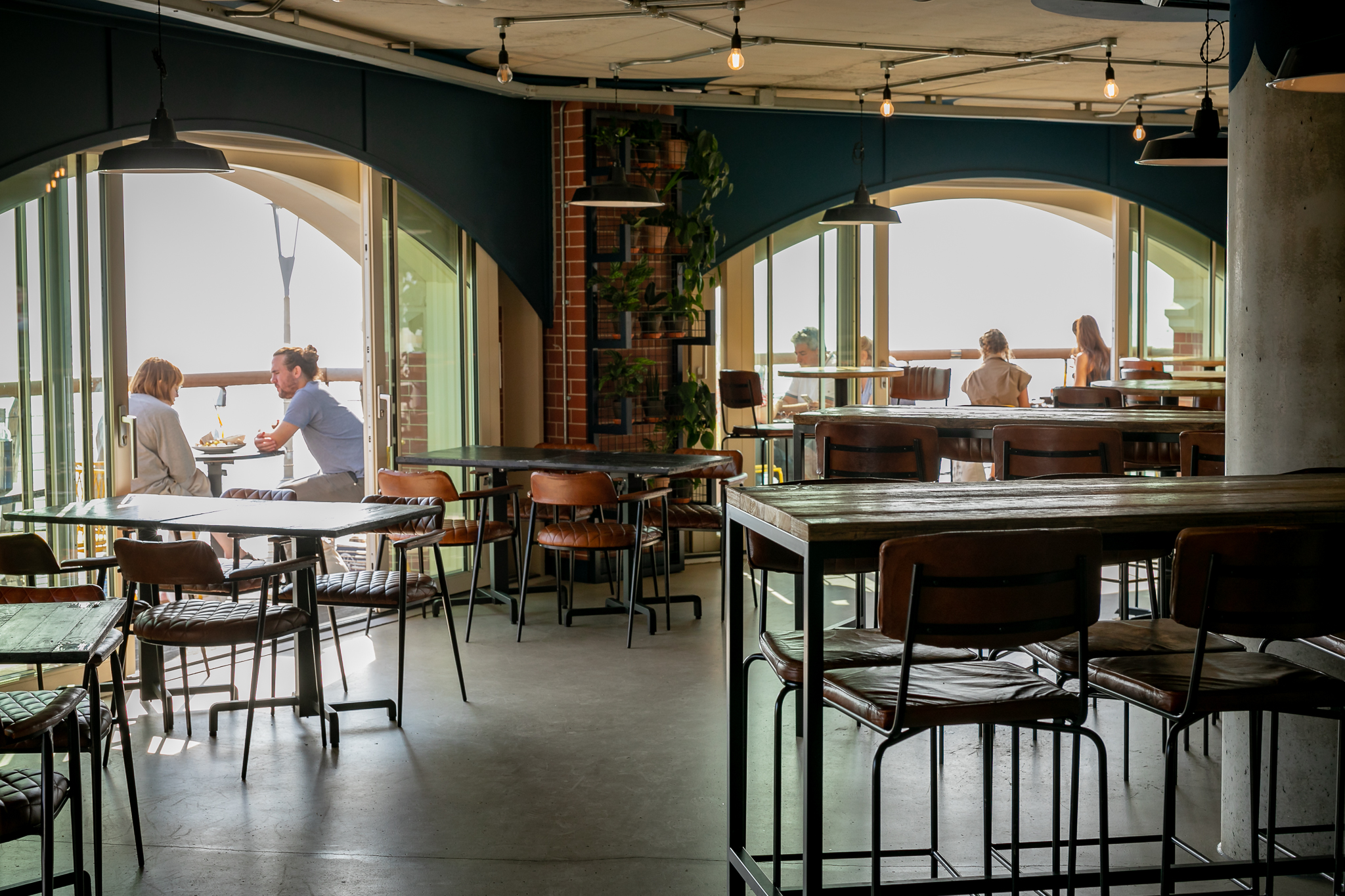 Stylish modern venue with large windows for intimate meetings and networking events.