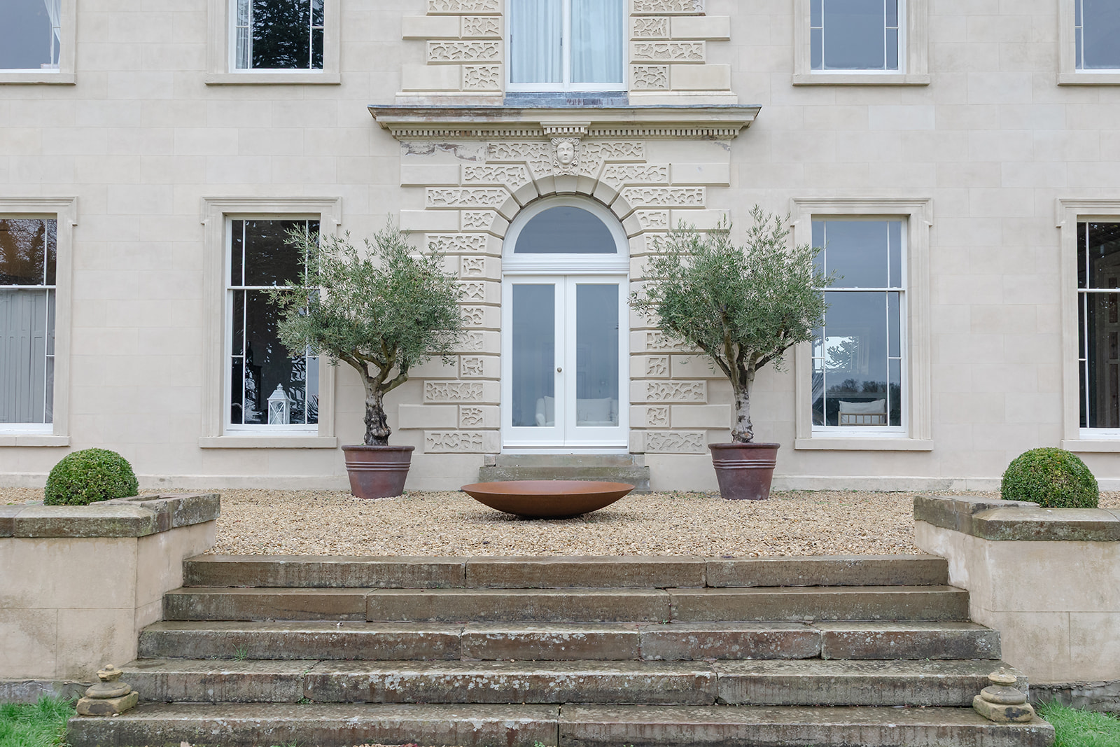 Elegant venue entrance with symmetrical facade for luxury events and outdoor corporate meetings.