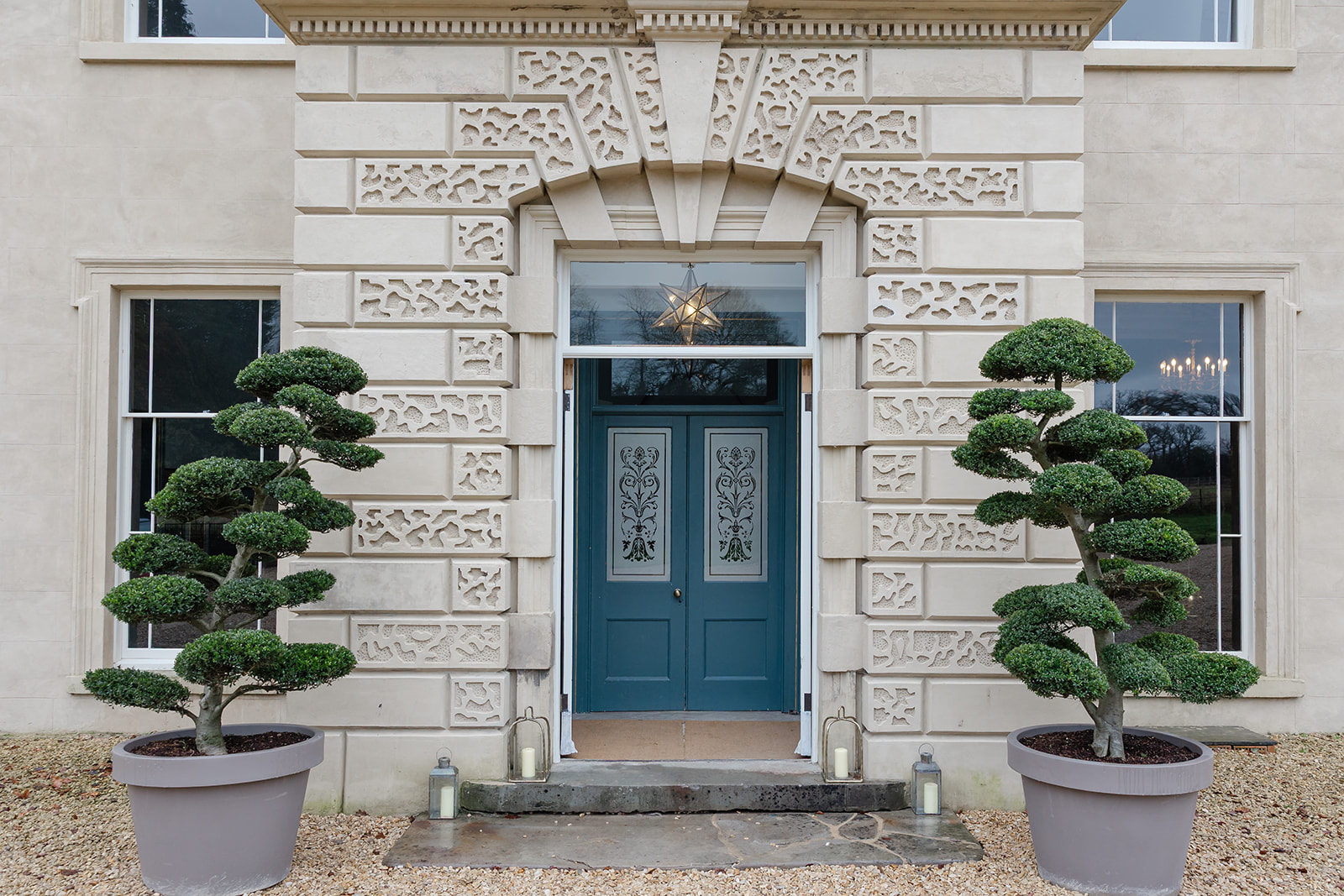 Grand topiary entrance at The Location House, perfect for luxury weddings and corporate retreats.