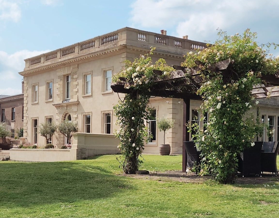 Historic estate venue for boutique retreats and wedding receptions with lush garden grounds.