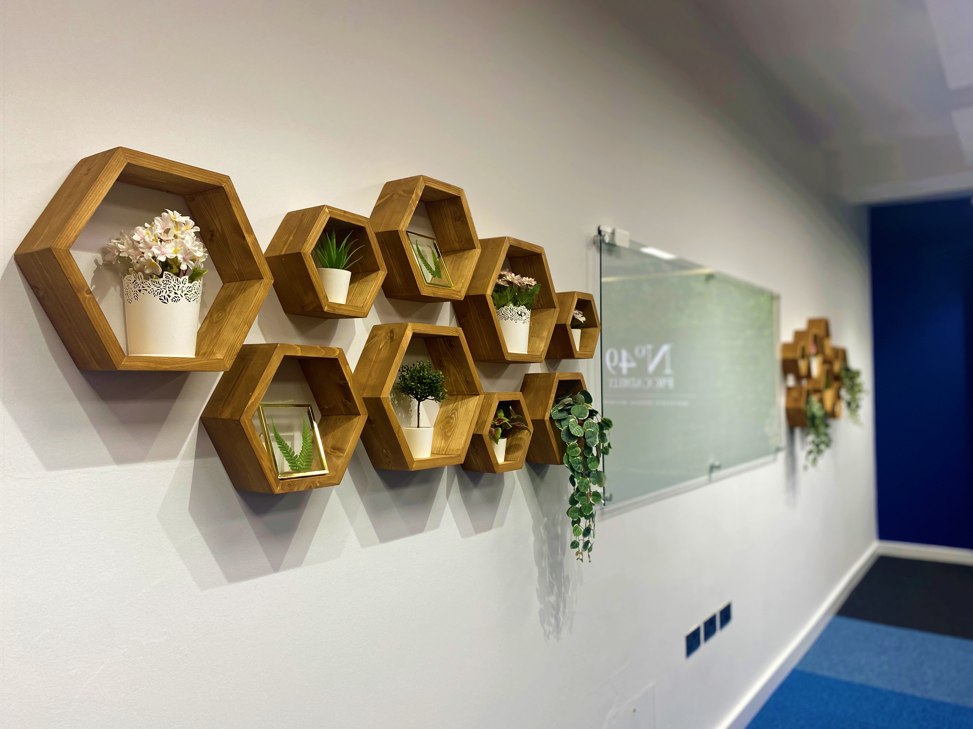Modern meeting space at Crompton, featuring a hexagonal plant display for collaboration.