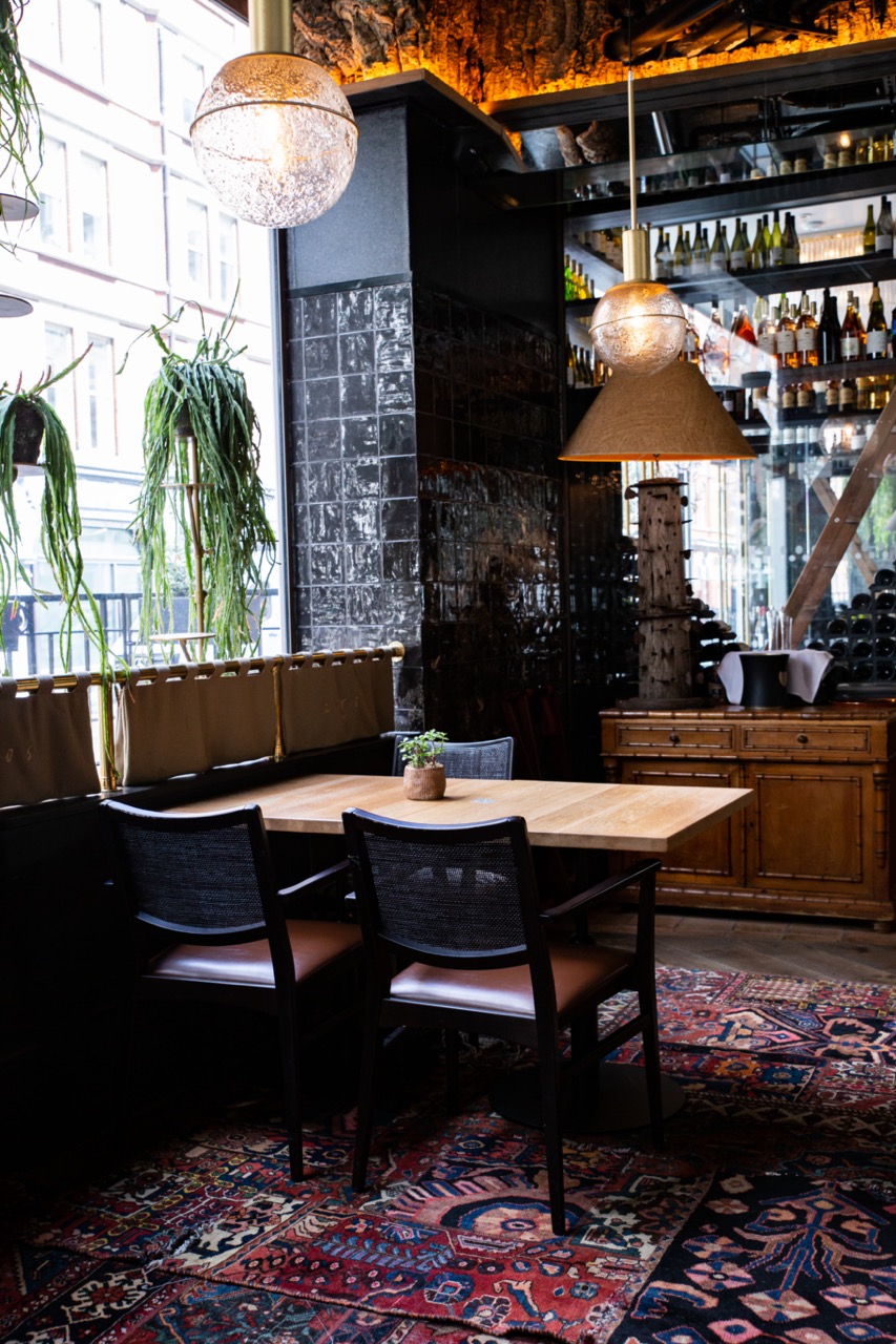 Stylish dining room with wooden table, perfect for intimate gatherings and meetings.