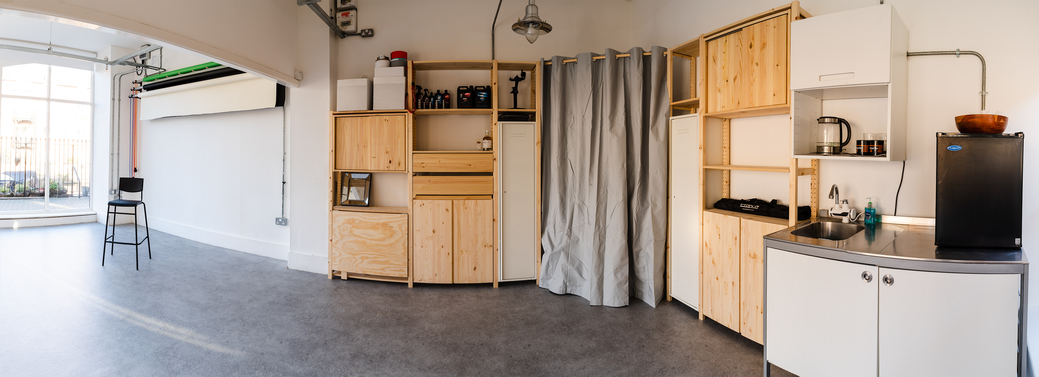 Versatile TiiC Studio event space with modular shelving for meetings and gatherings.