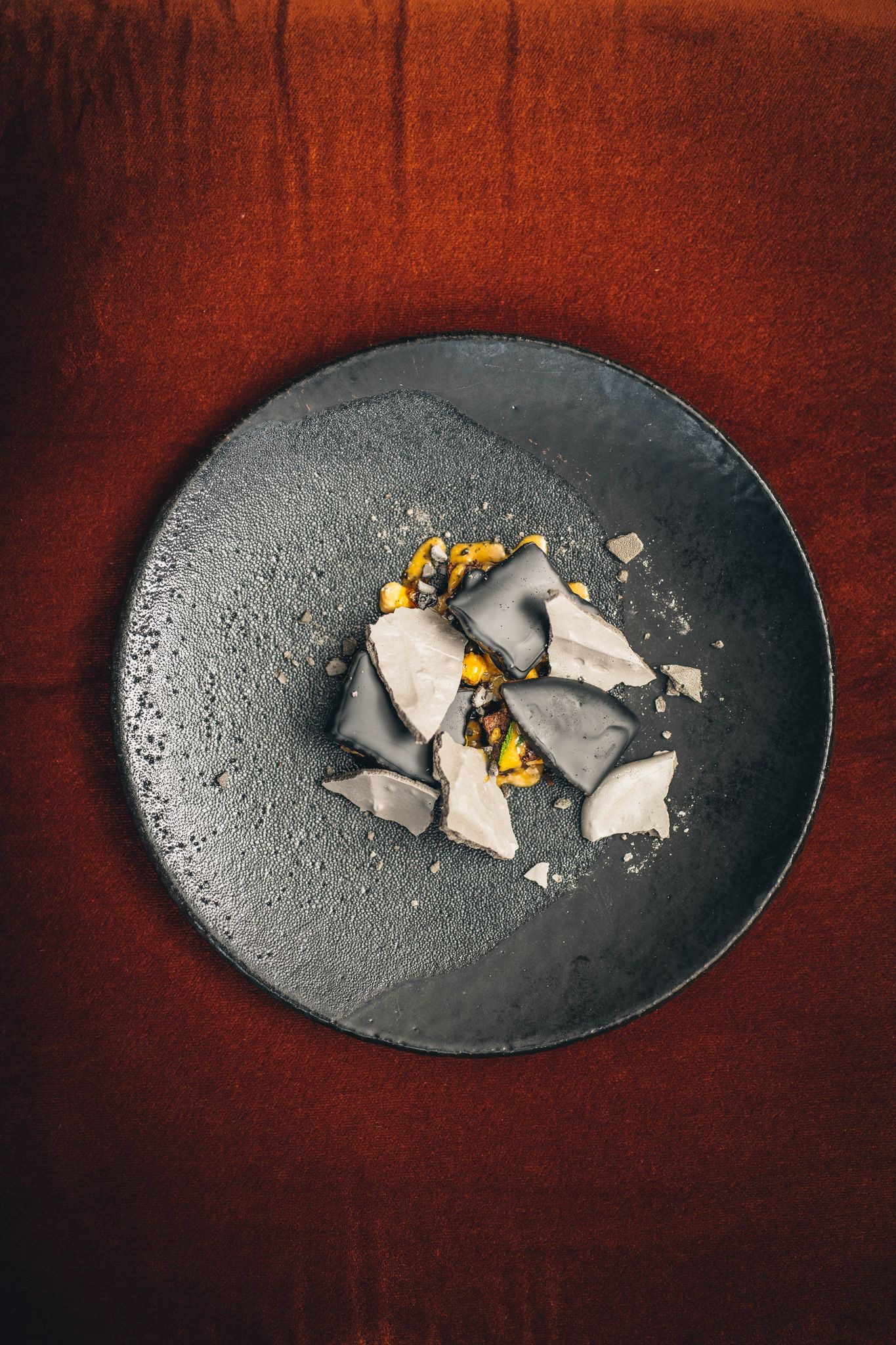 Artistic dessert with dark chocolate and corn at Arros QD for upscale events.