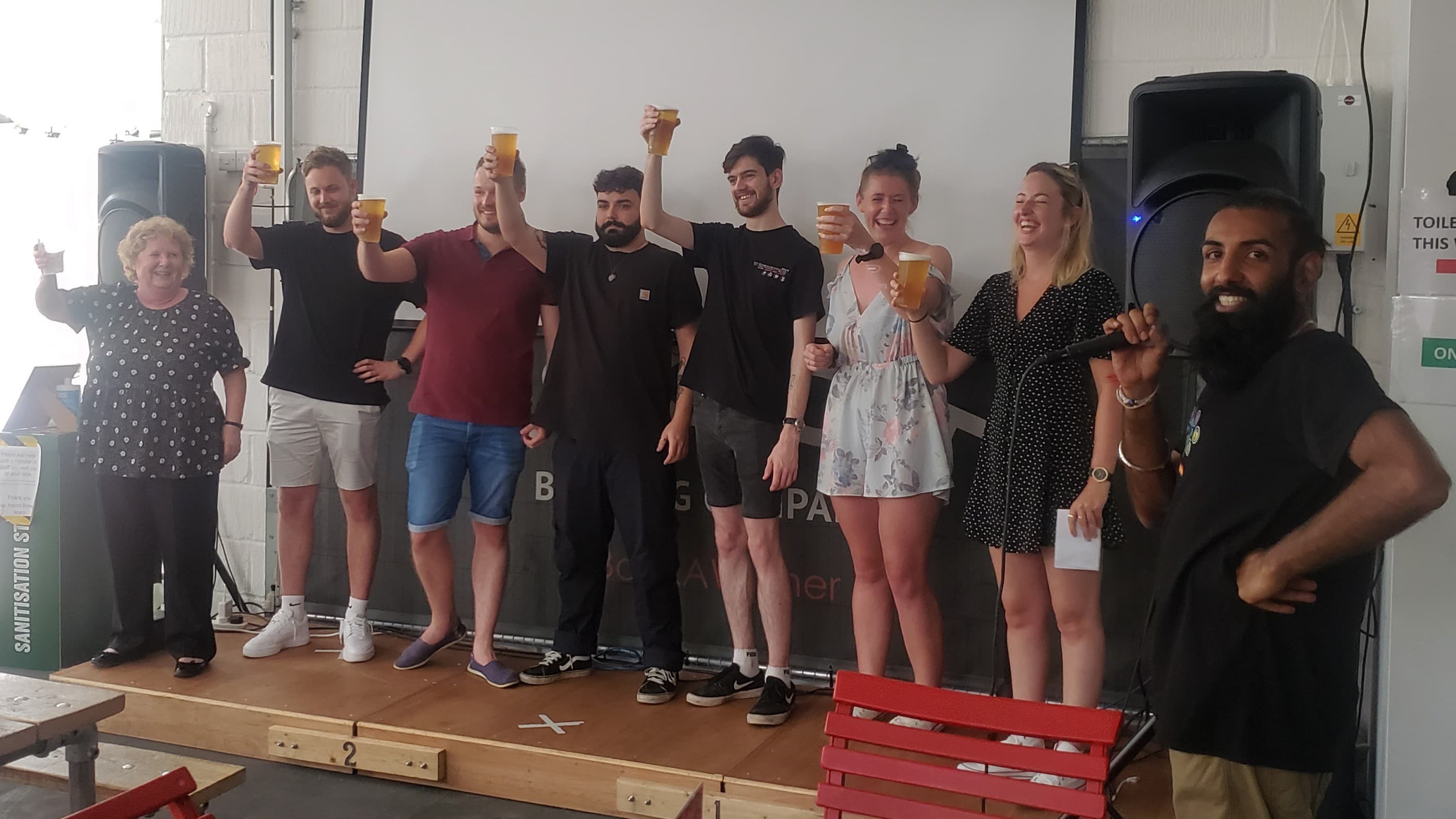 Group toasting drinks at Ascot Brewing, perfect for team-building and celebrations.