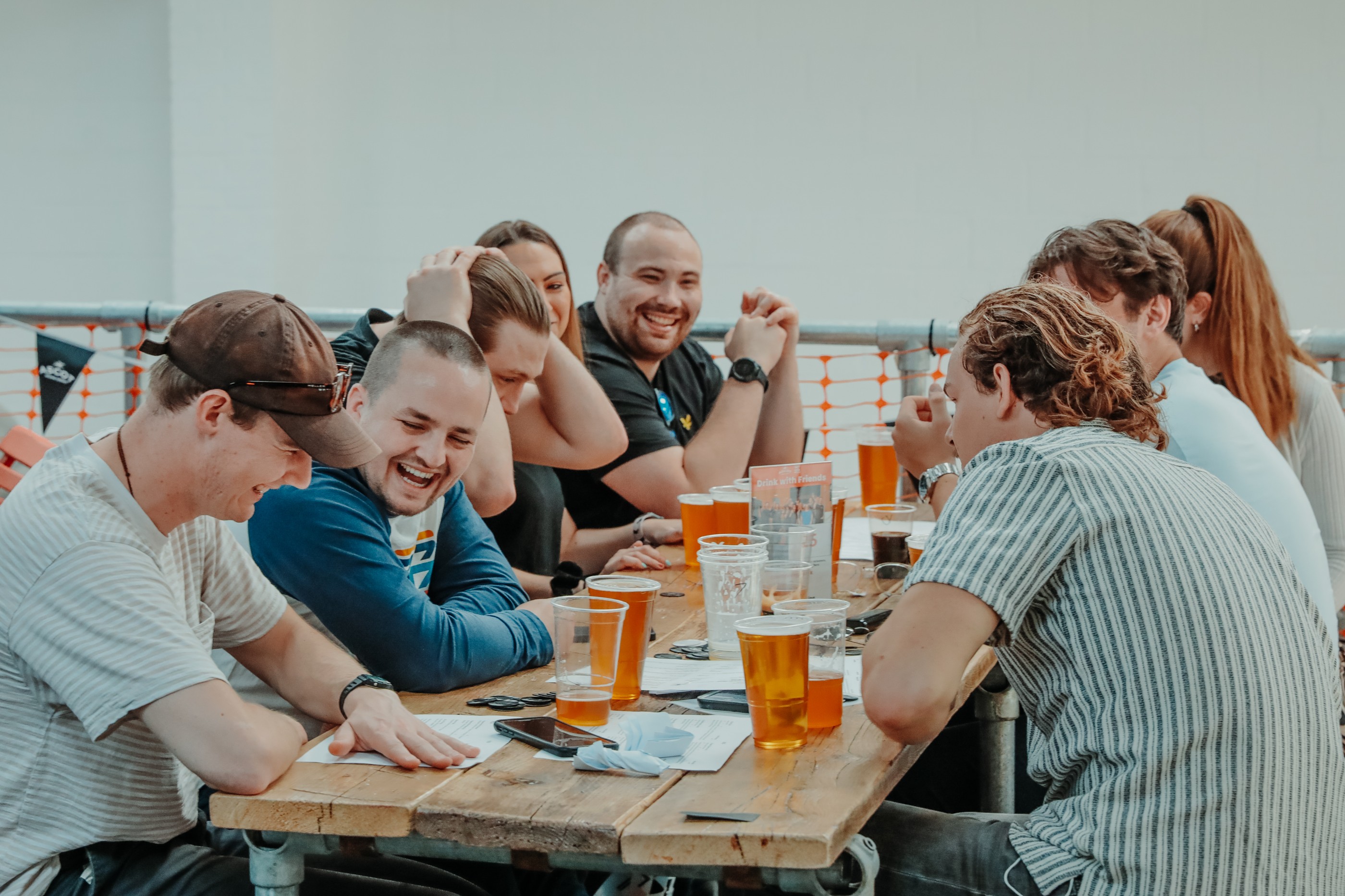 Lively networking event at Ascot Brewing with drinks and laughter.