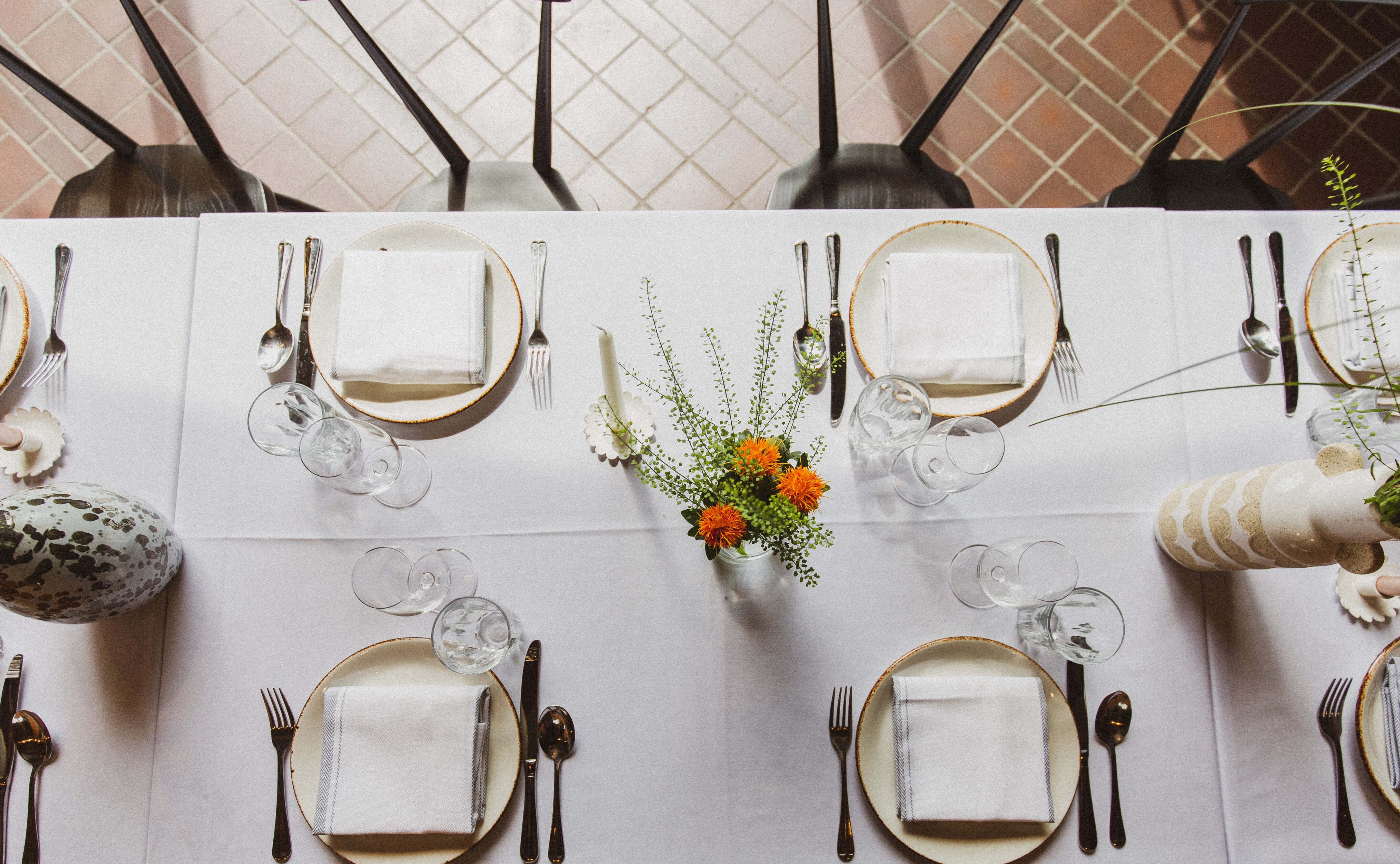 Elegant dining table setup with floral centerpiece for formal events at Ducie Street Warehouse.