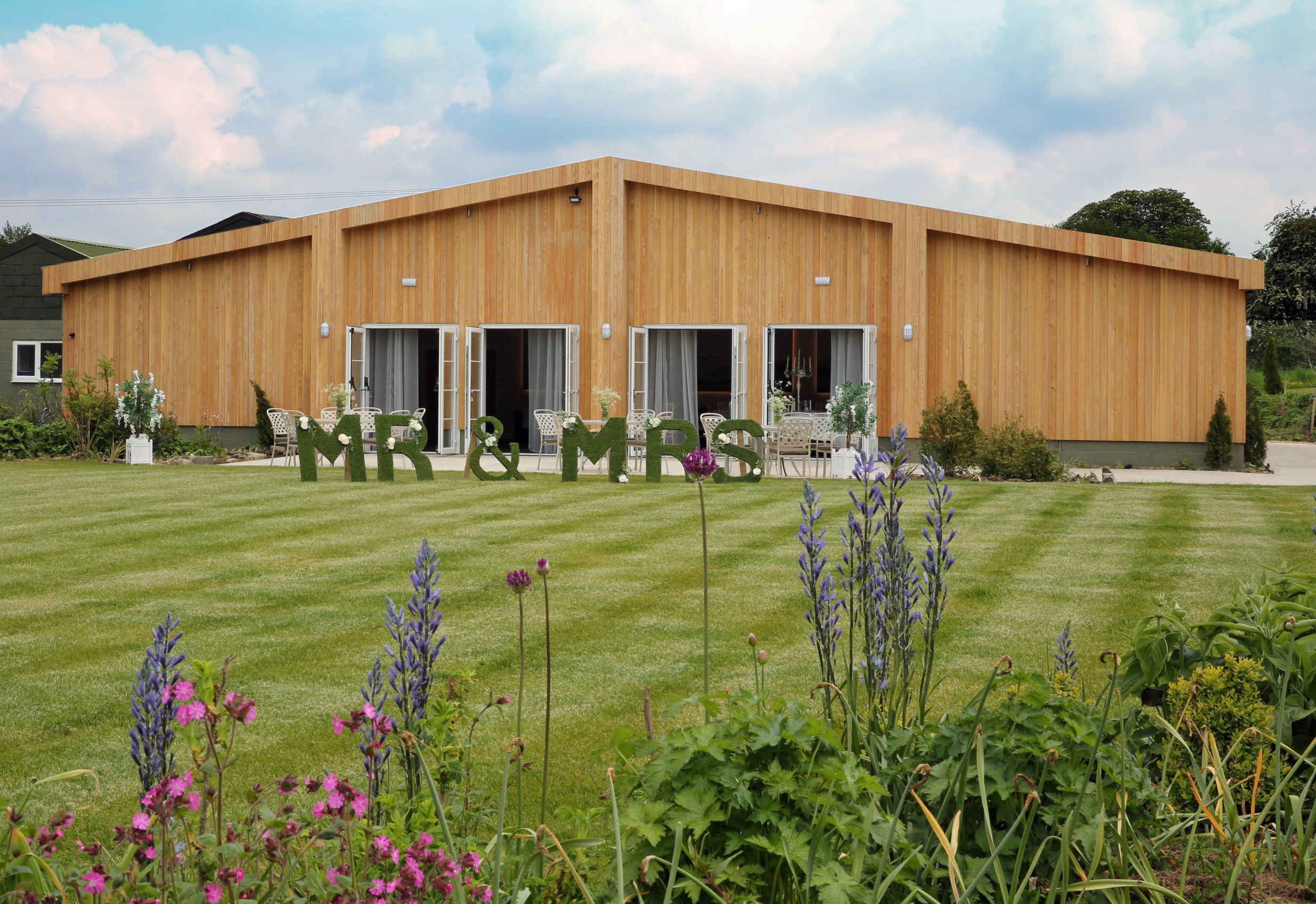 Eaton Manor Events Centre: modern wooden venue for weddings with floral accents and natural light.