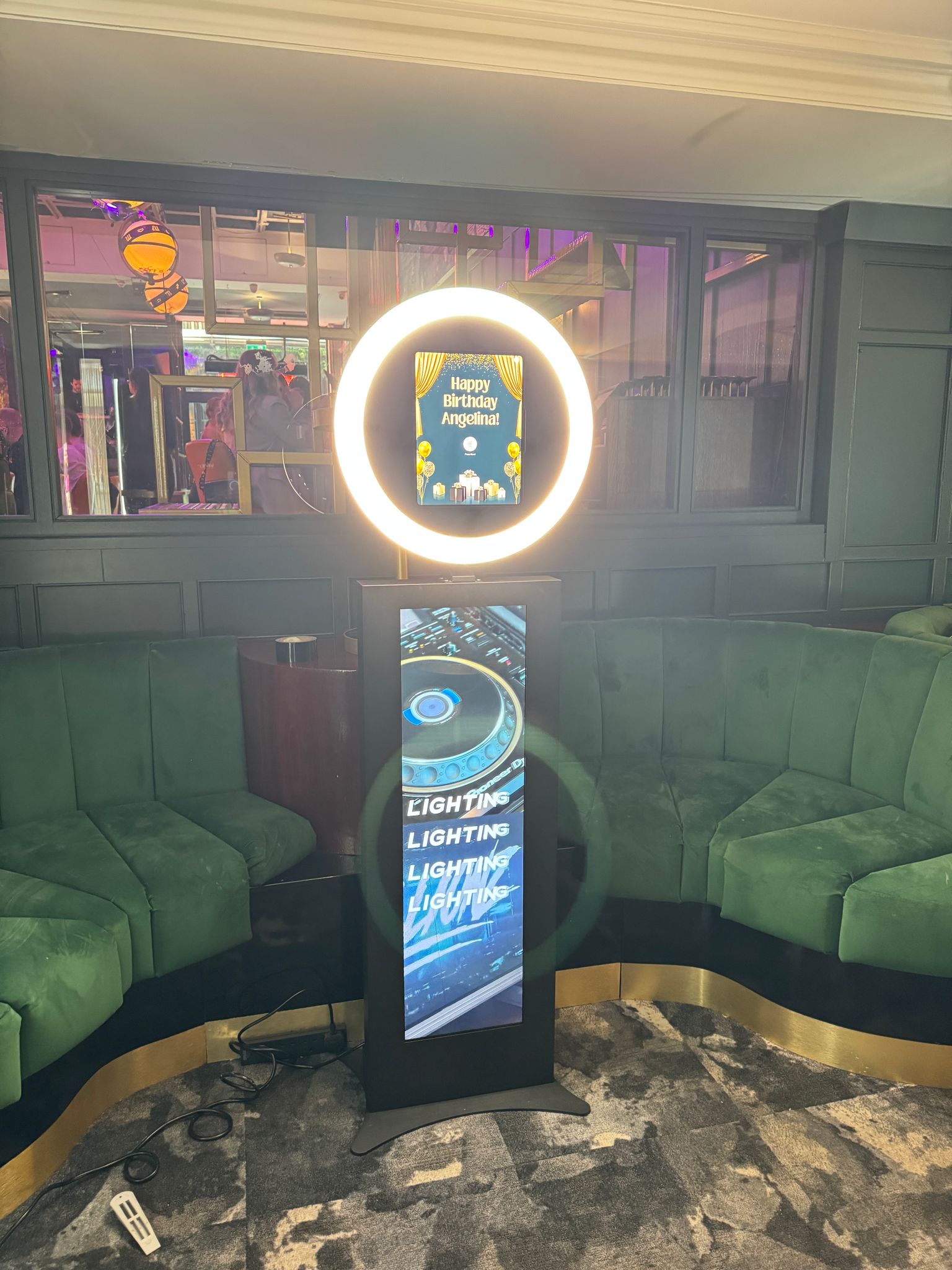 Vibrant birthday event setup at BLVD Spinningfields with digital display and cozy seating.