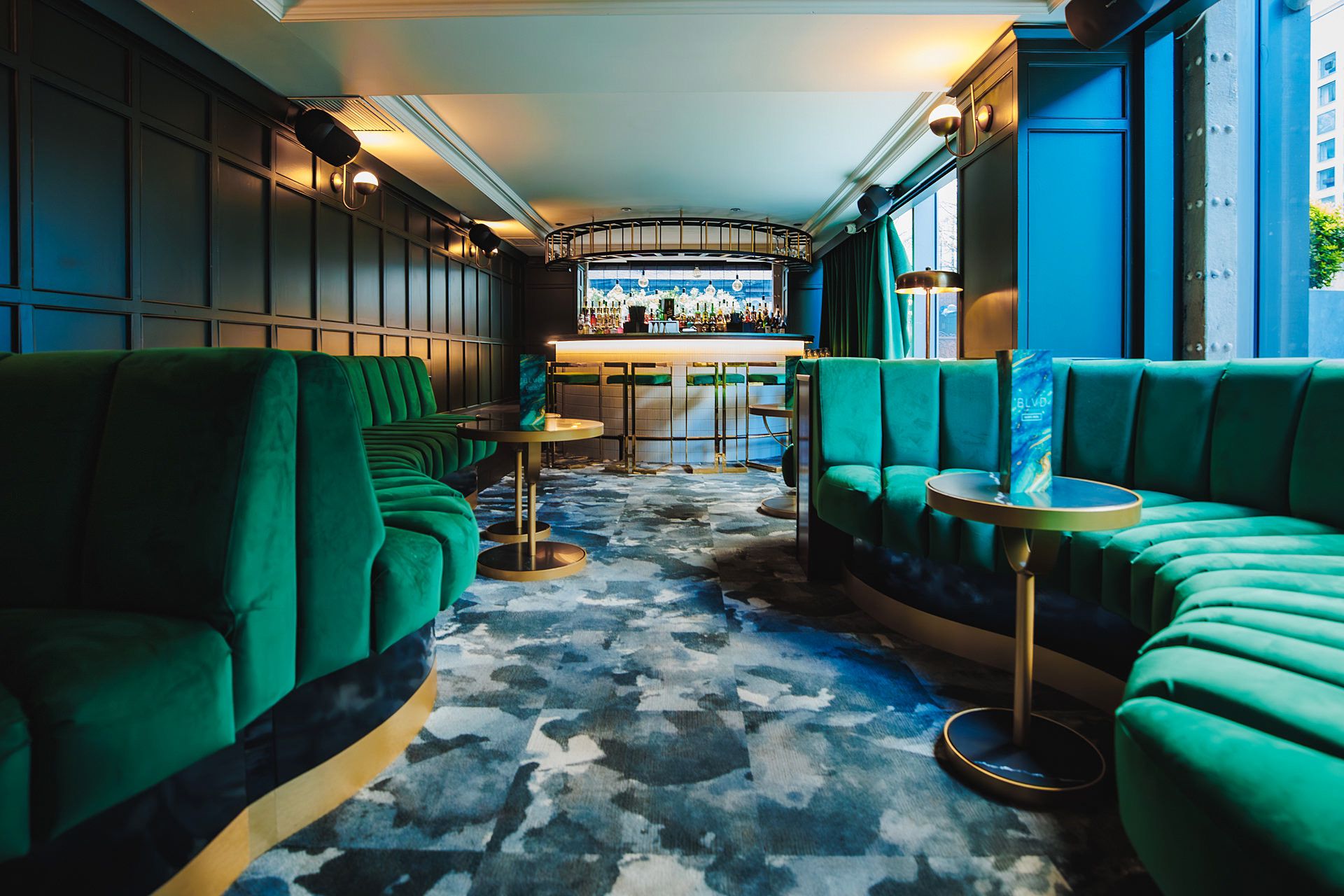 Stylish lounge with plush green seating, ideal for upscale events and networking.