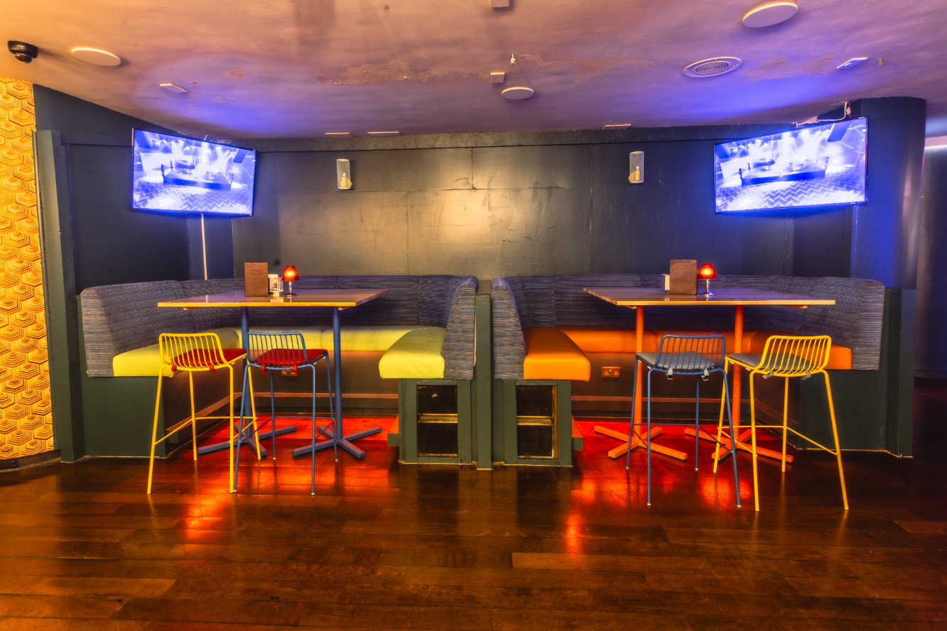Modern meeting space with cozy booths at The Piano Works West End for events and presentations.