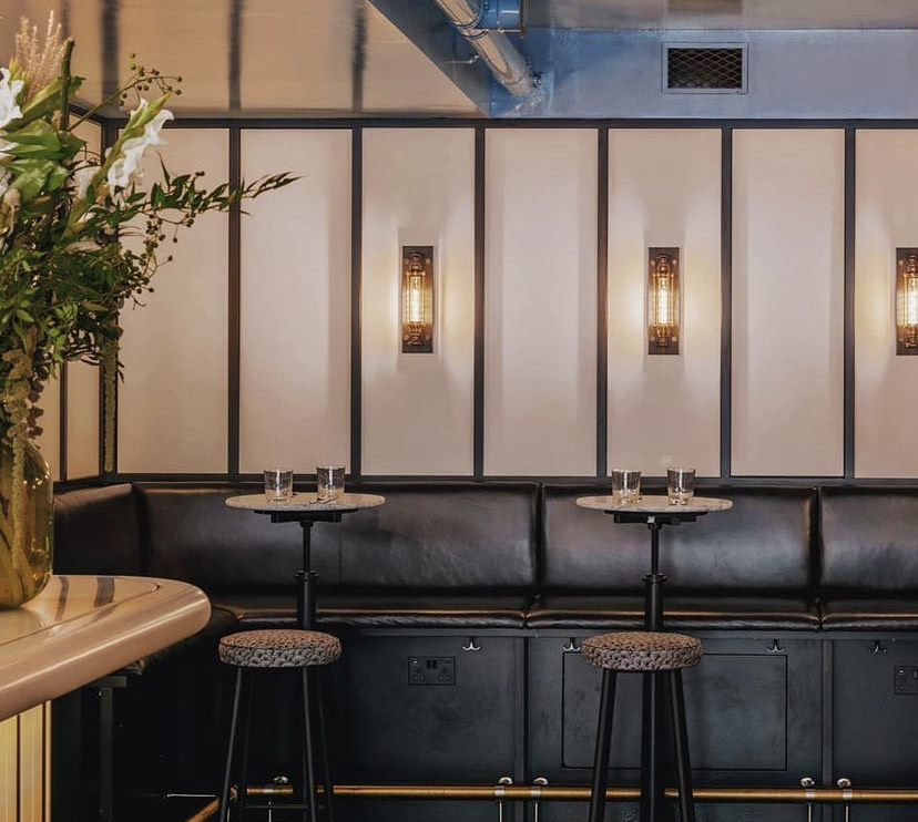 Stylish meeting space with black leather seating, perfect for networking events.