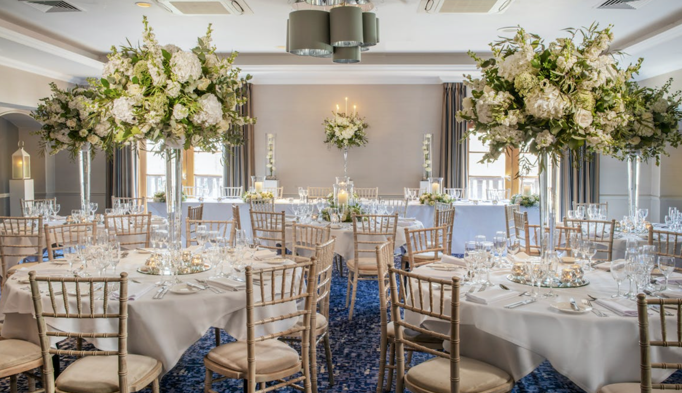 Elegant Hambledon suite with floral centerpieces, ideal for weddings and formal events.