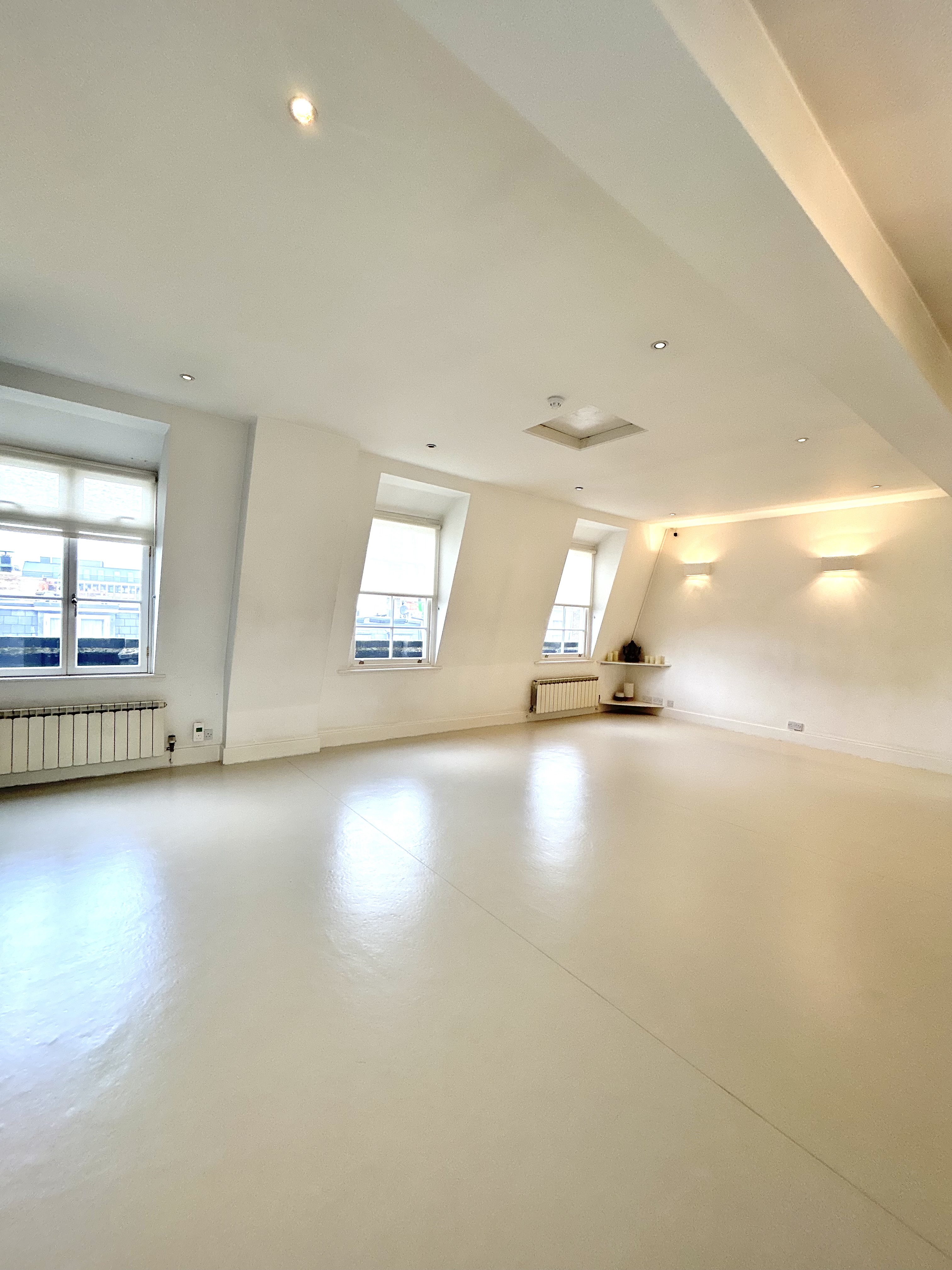 Modern Loft Studio event space with slanted windows for workshops and gatherings.