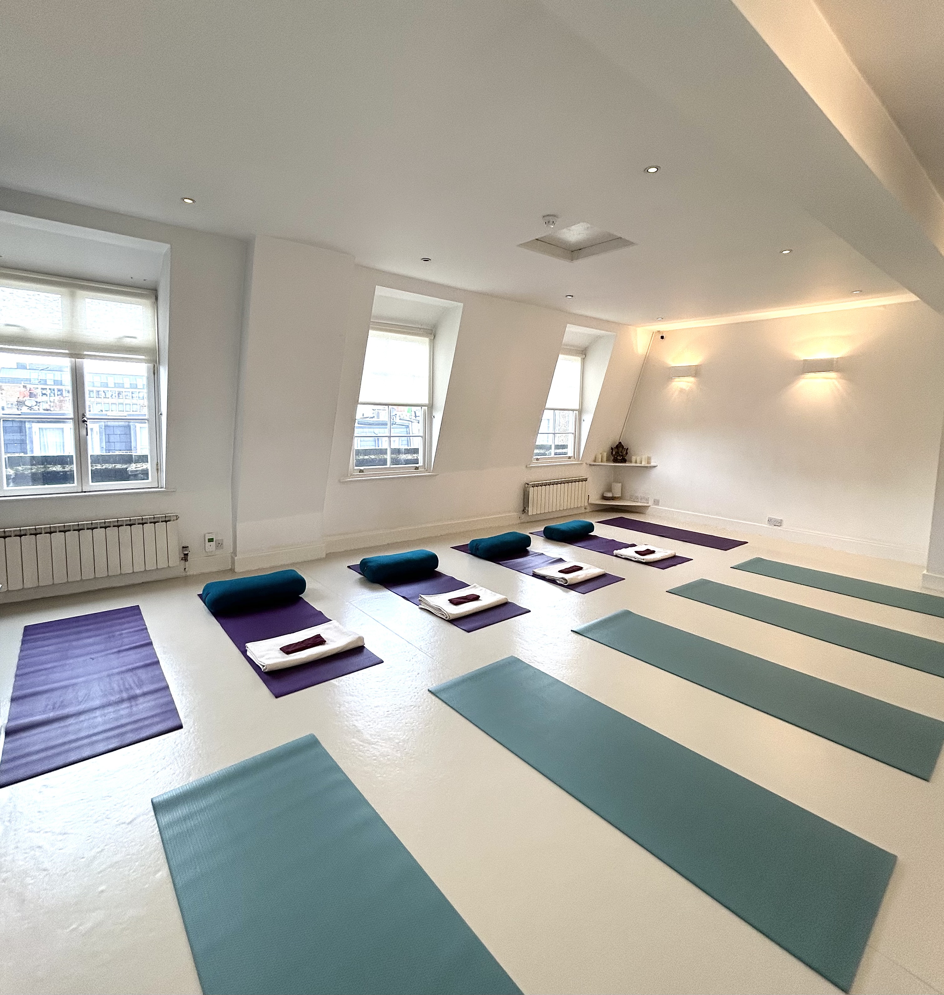 Serene yoga studio with natural light, ideal for wellness retreats and team-building events.