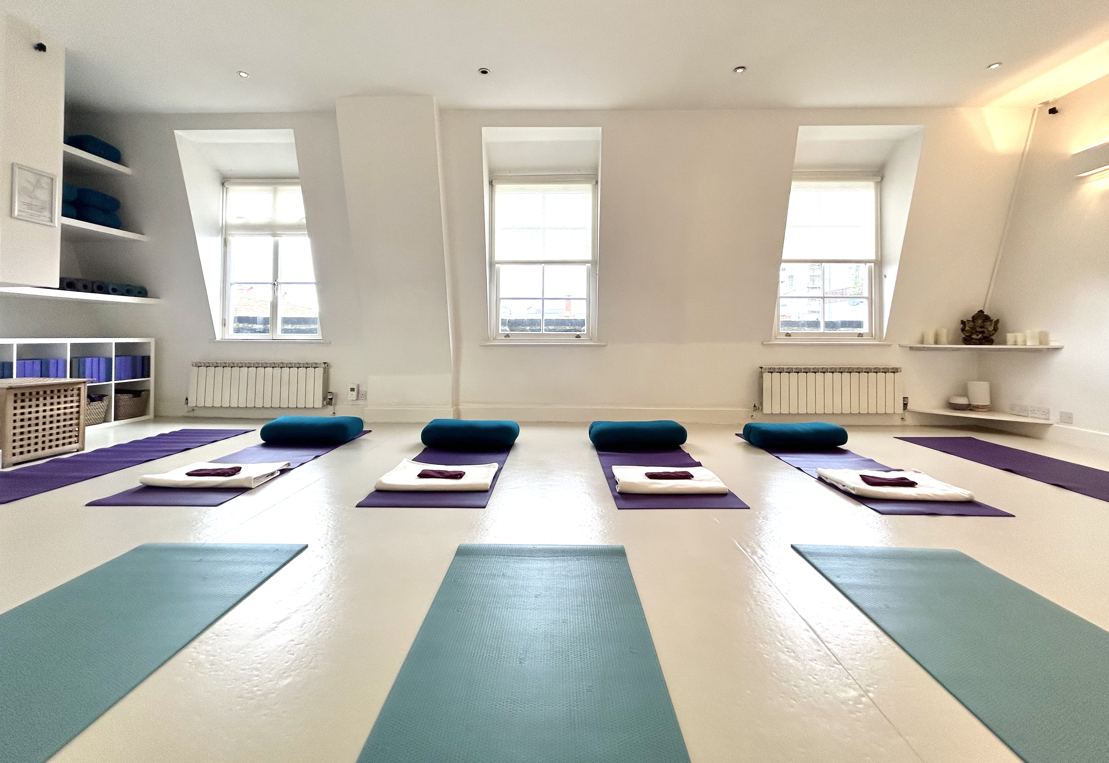 Spacious yoga studio with natural light, ideal for wellness retreats and mindfulness workshops.