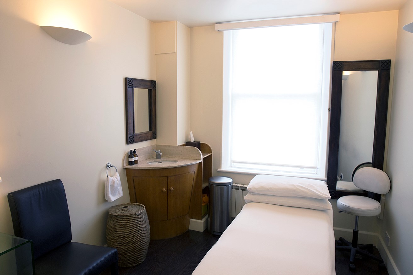 Serene treatment room with a massage table for wellness retreats and mindfulness events.