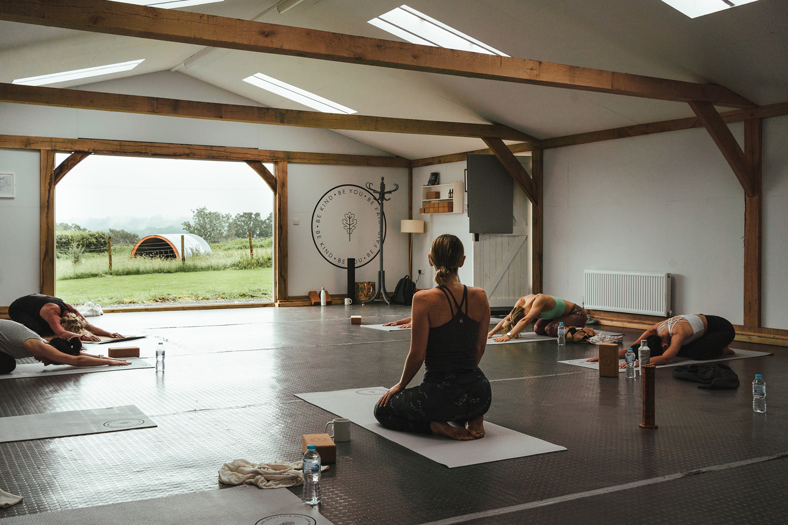 Serene yoga session in bright studio at Fair Oak Farm for wellness retreats and team-building.