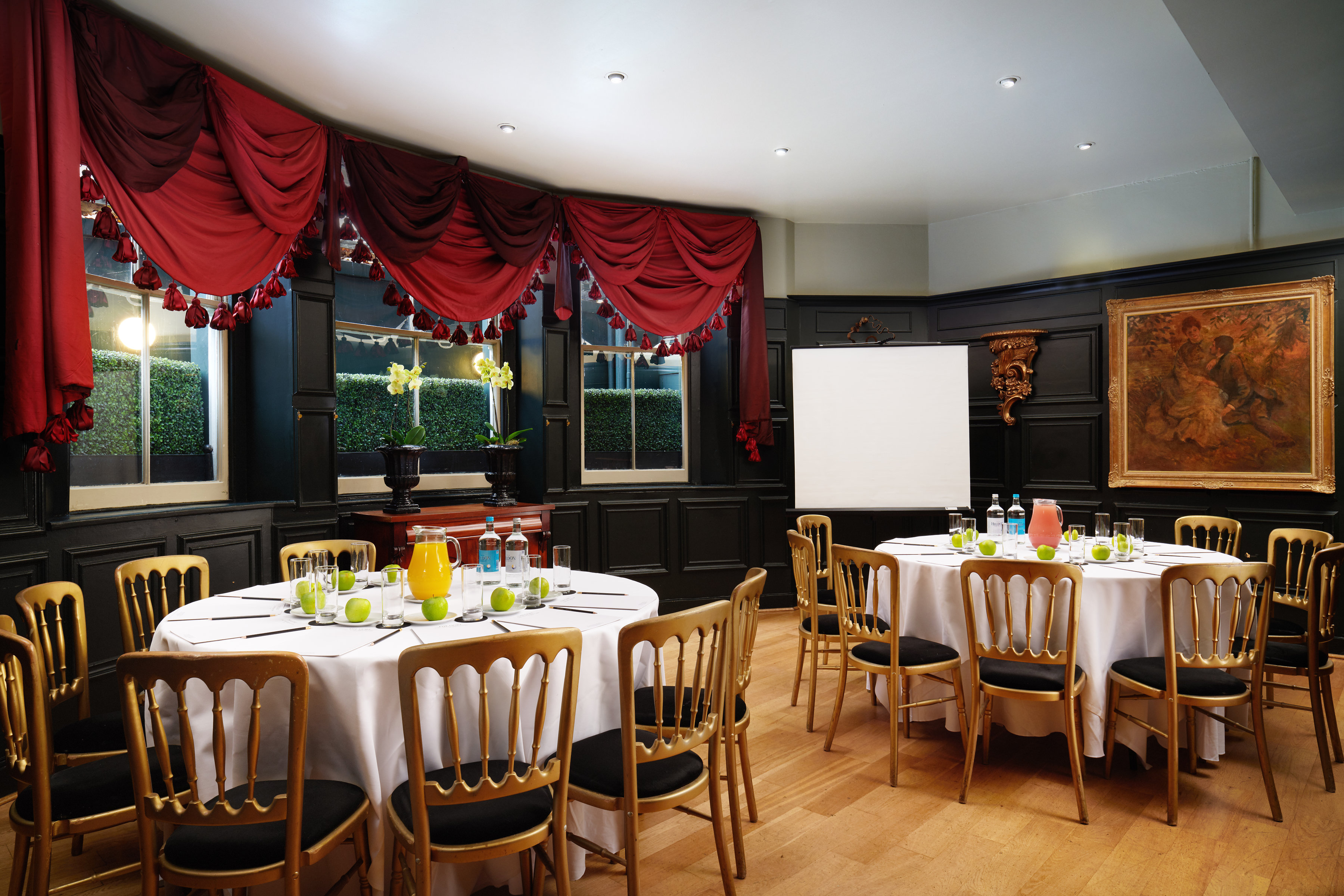 Elegant meeting space with round tables, ideal for workshops and small conferences.