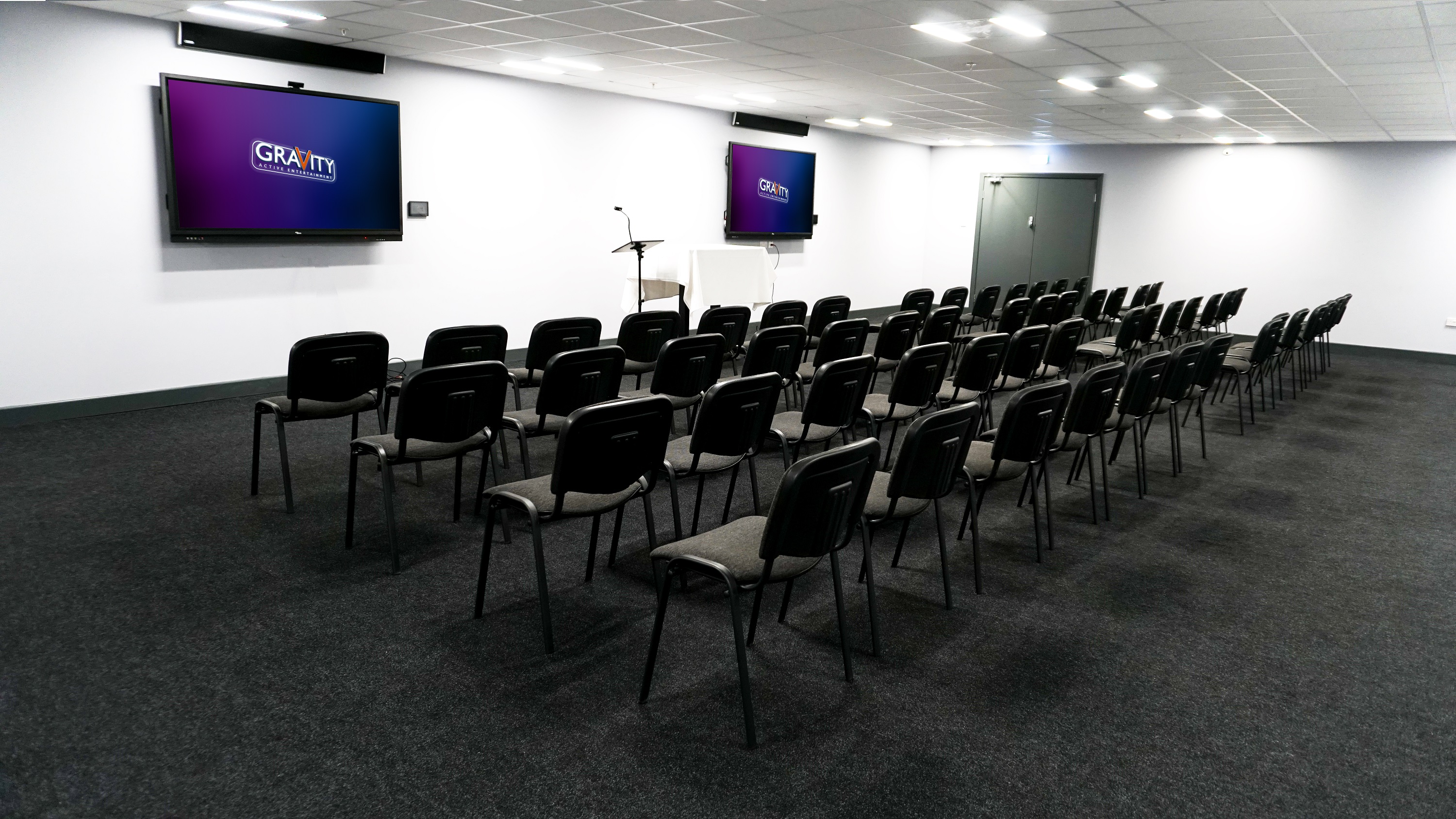 Gravity Wandsworth meeting space with large screens for workshops and presentations.
