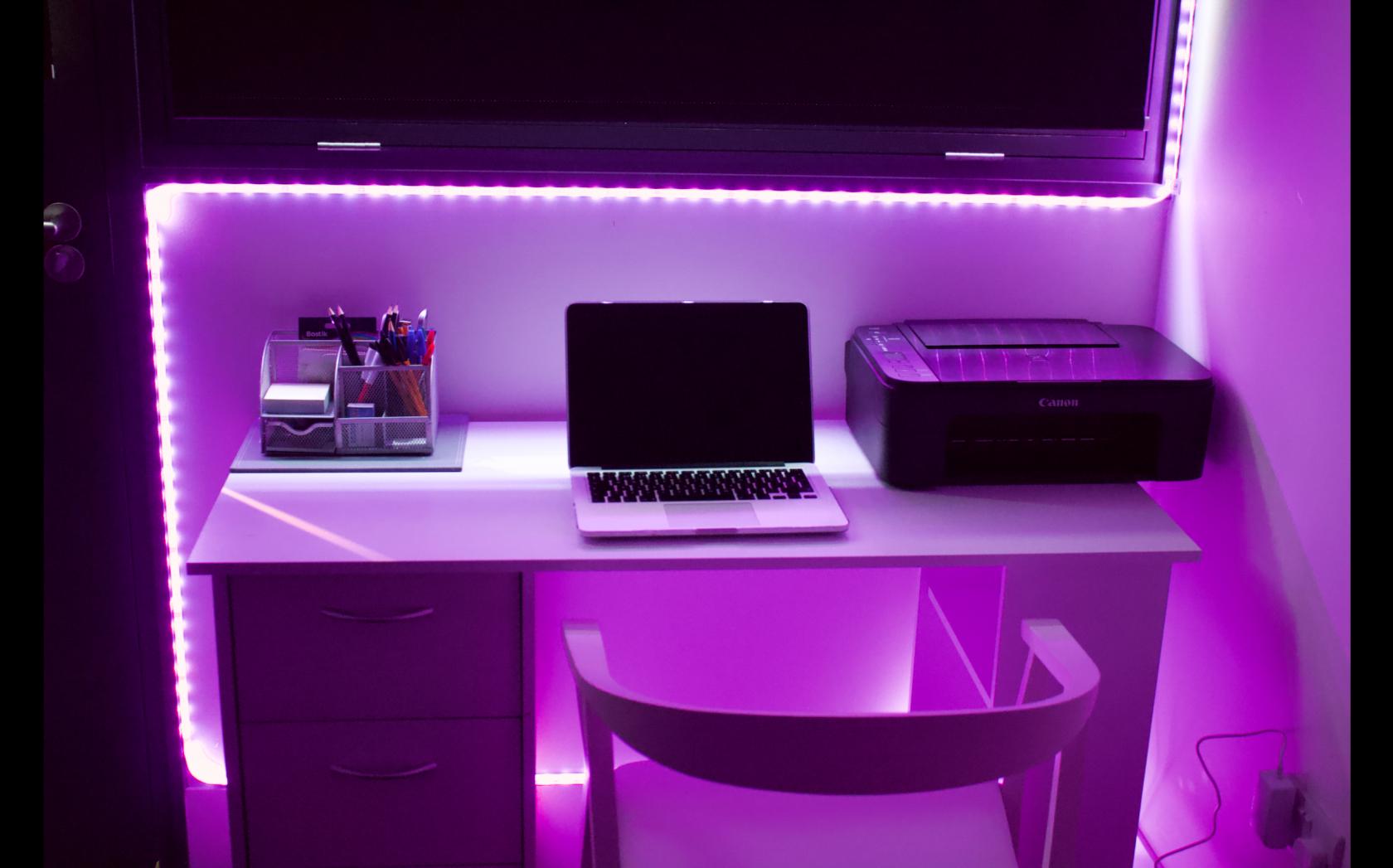 Modern podcast meeting room with purple lighting for creative events and productivity.