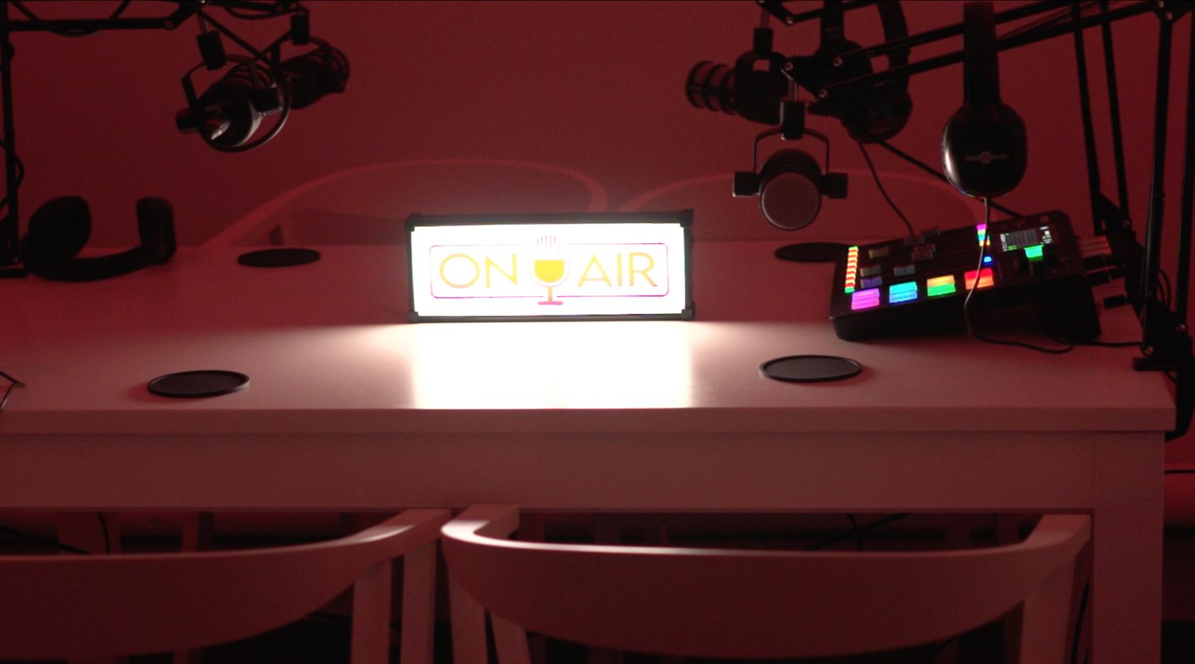 Podcast studio with "ON AIR" sign, ideal for hybrid events and media production