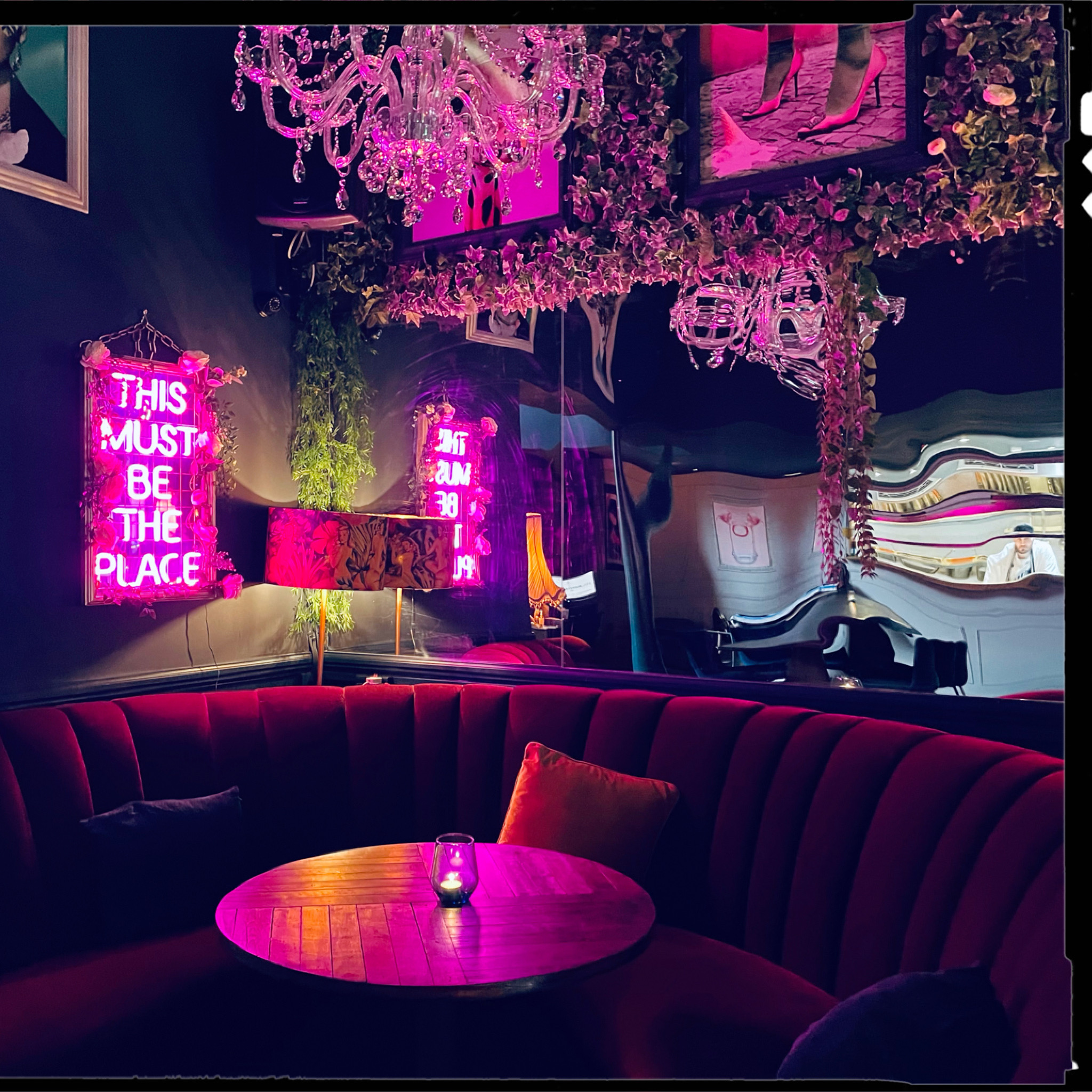 Vibrant Imperial Arms Lounge with neon signs, ideal for networking and social events.