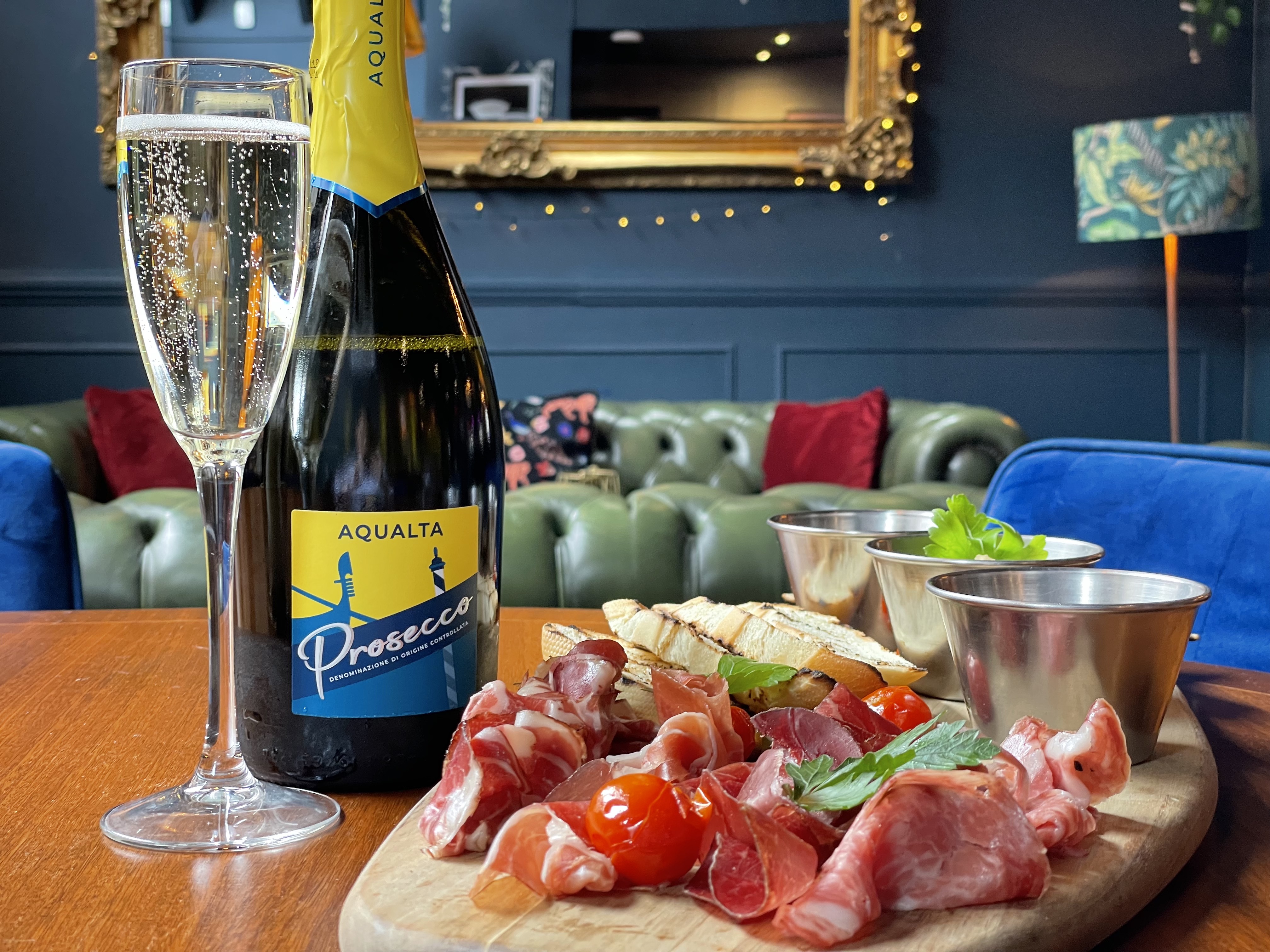 Elegant lounge setup with prosecco and charcuterie for networking events.