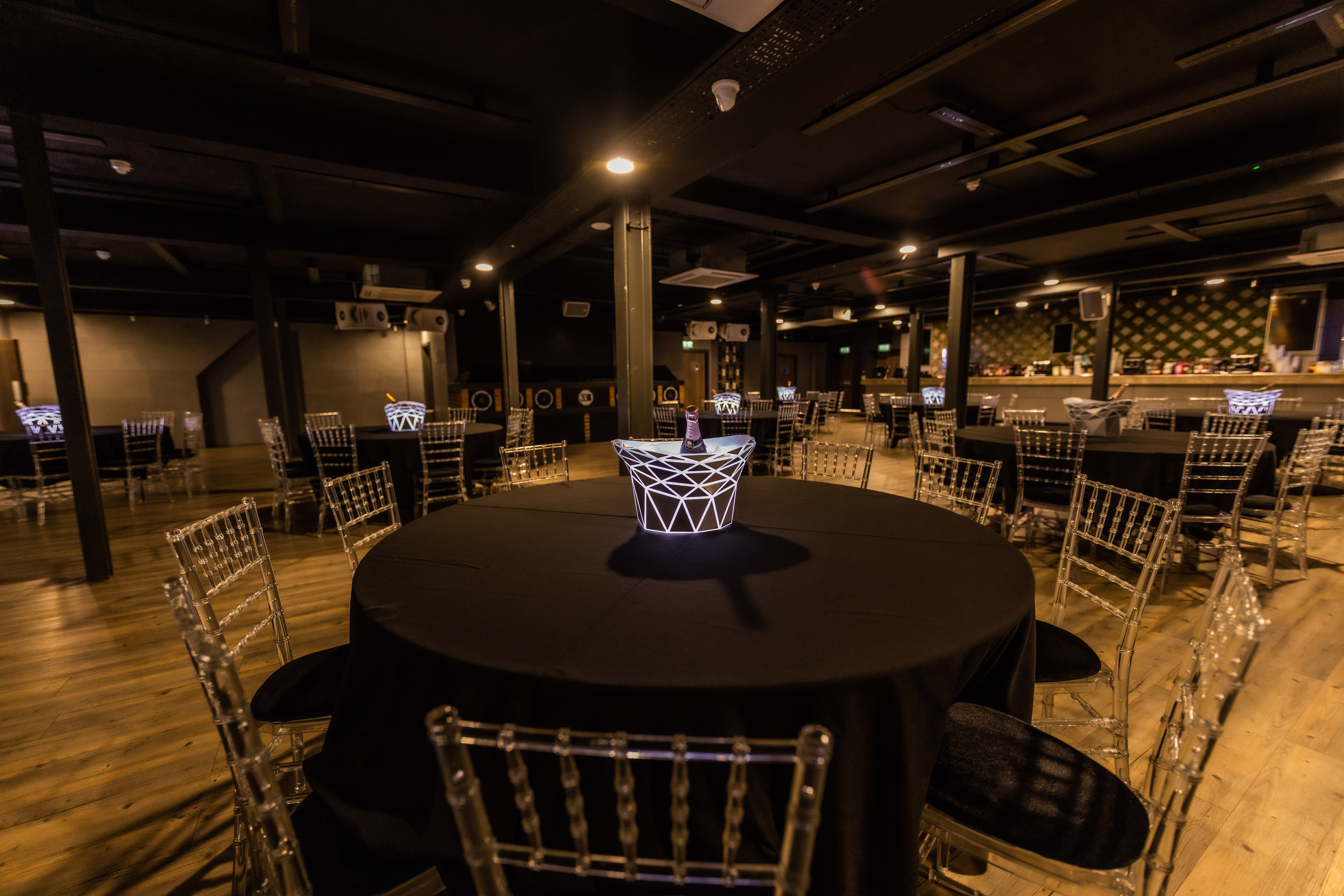 Elegant event space with round tables and chiavari chairs at Studio 338.