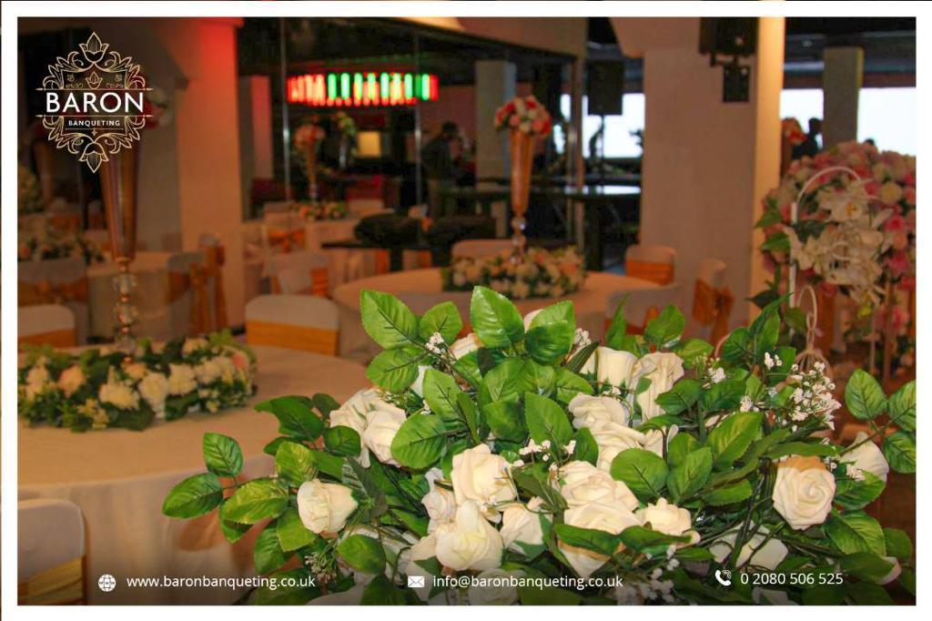Elegant event space at Baron Lounge with floral centerpieces, perfect for weddings.