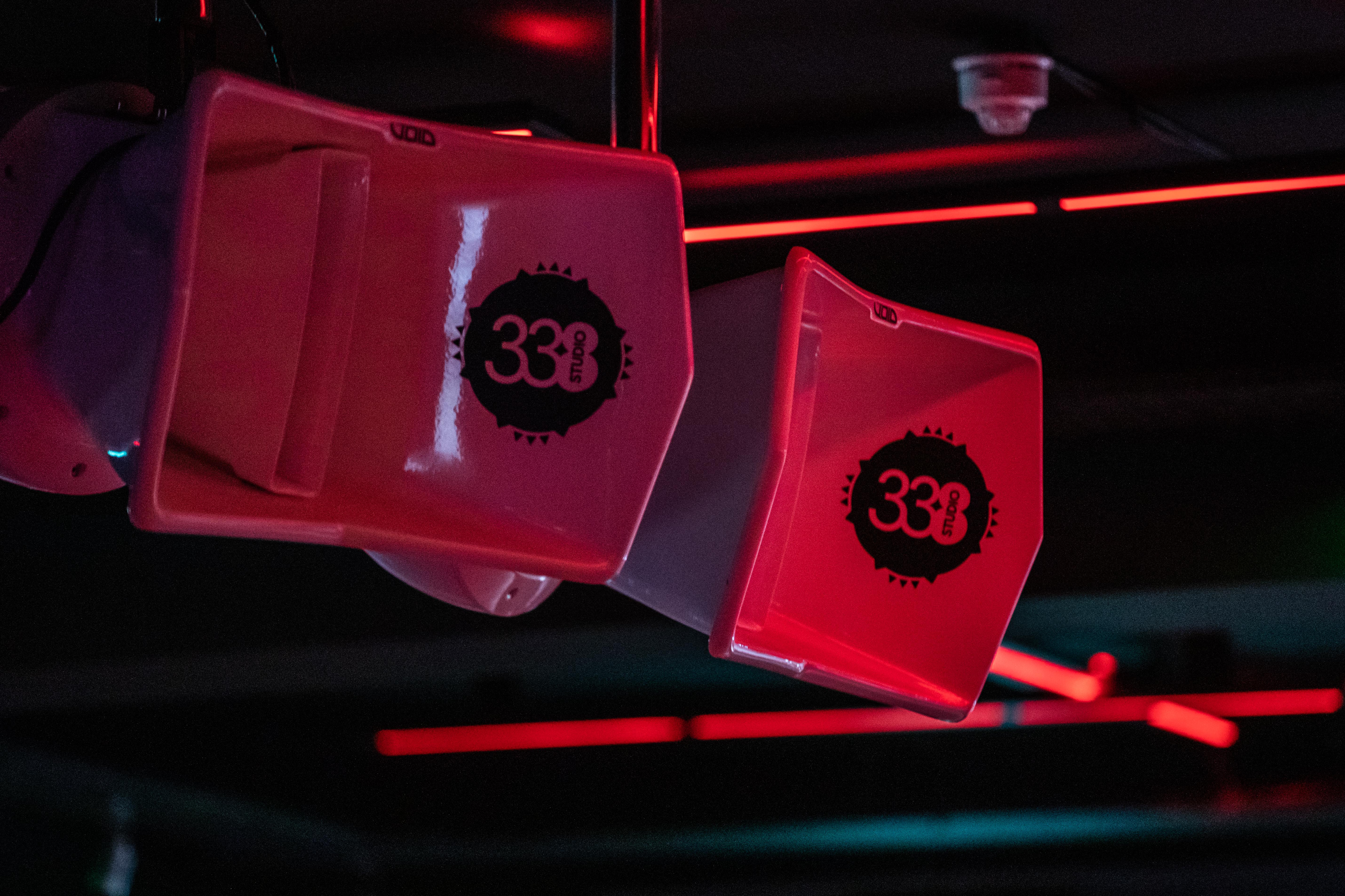 Close-up of audio speakers in vibrant red lighting at Studio 338 event venue.